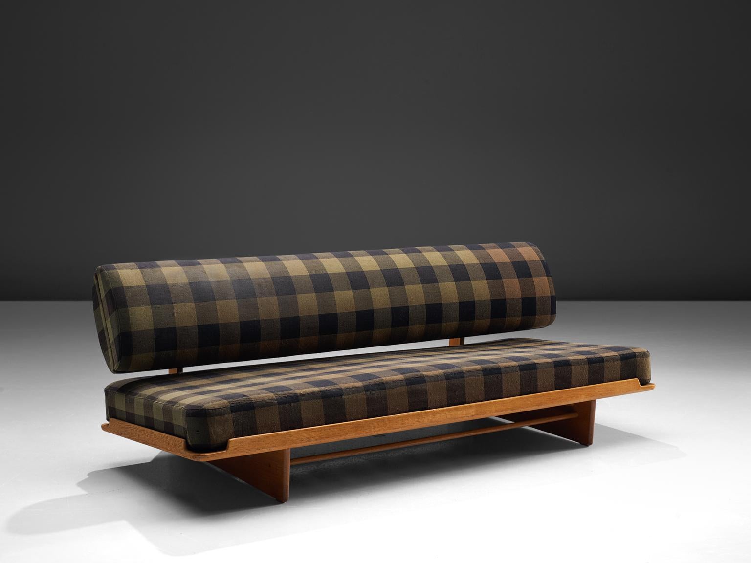 Grete Jalk for P. Jeppesen, daybed, oak, checked olive green and black wool, Denmark, 1960s. 

This daybed is designed by Grete Jalk and has slatted legs. The piece features various quirky design elements such as the storage in the back cushion,