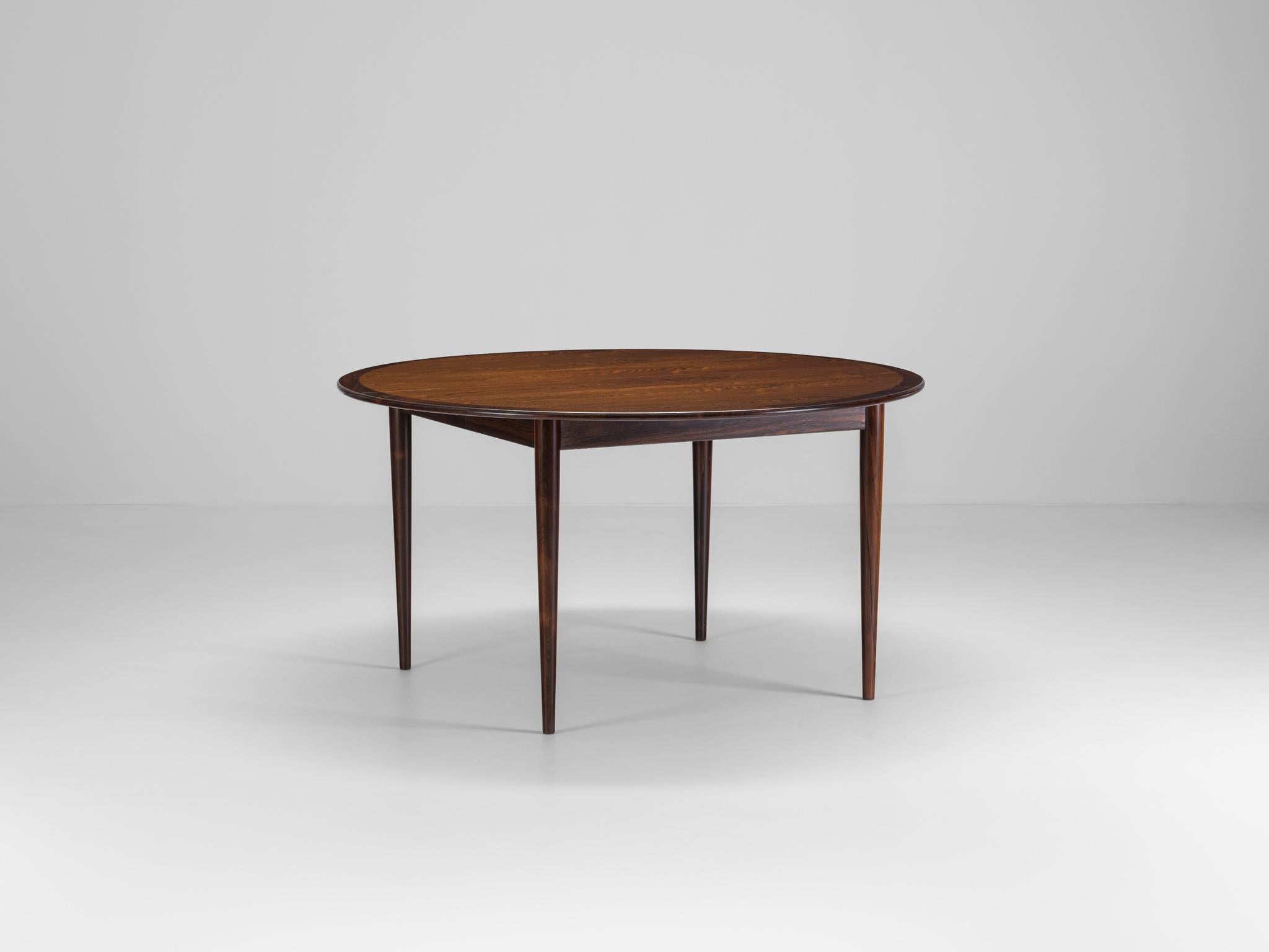 Rosewood dining table designed by Grete Jalk and Produced by P. Jeppesens møbelfabrik in Denmark c 1960

The table is round with very large diameter of 136 cm, and have two extension leafs with 136x55 cm each. 
Both extra leafs have the sarg and
