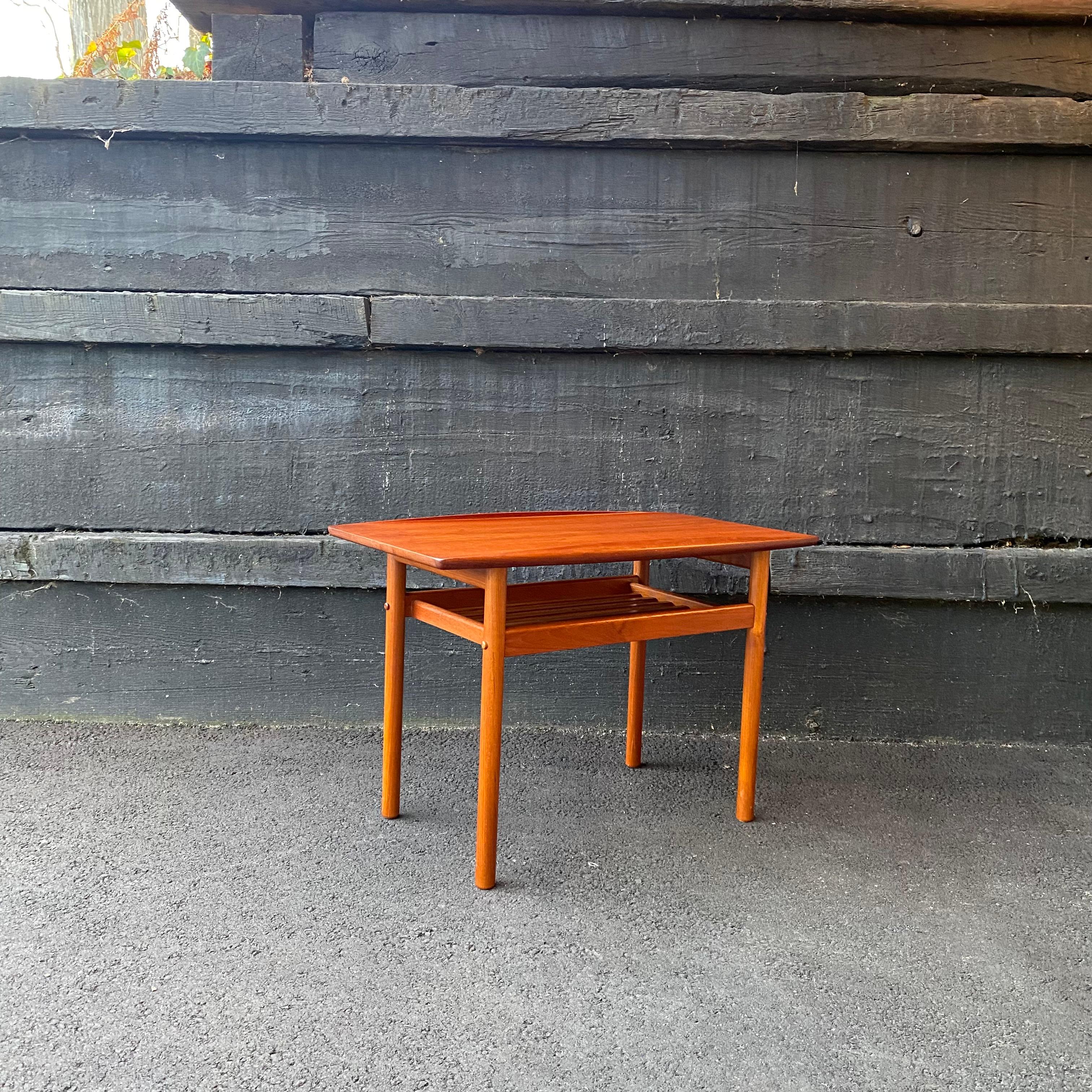 This is a beautiful sculpted teak side or end table designed by Grete Jalk for Poul Jeppesen, ca. 1960’s. There is a shelf made of slatted wood under the table top for storage. This piece came from Denmark to the US in the 1980’s. 

Condition: