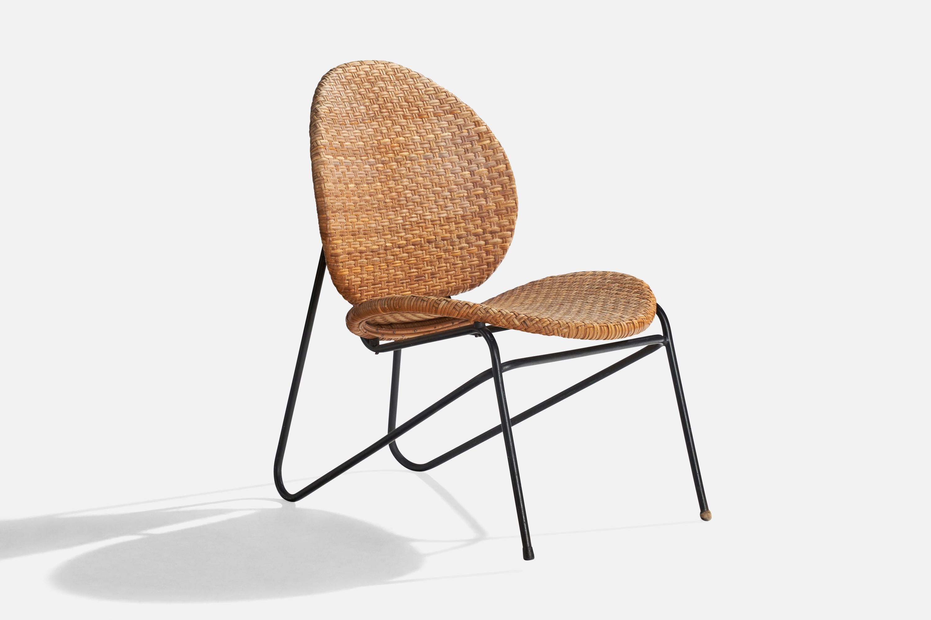 A rare black-lacquered tubular steel and rattan lounge chair designed by Grete Jalk in 1952 and produced by Laurids Lønborg, Denmark, 1950s.

Missmatched caps on front lets, one in rubber, one in wood.

Seat height: 15.25