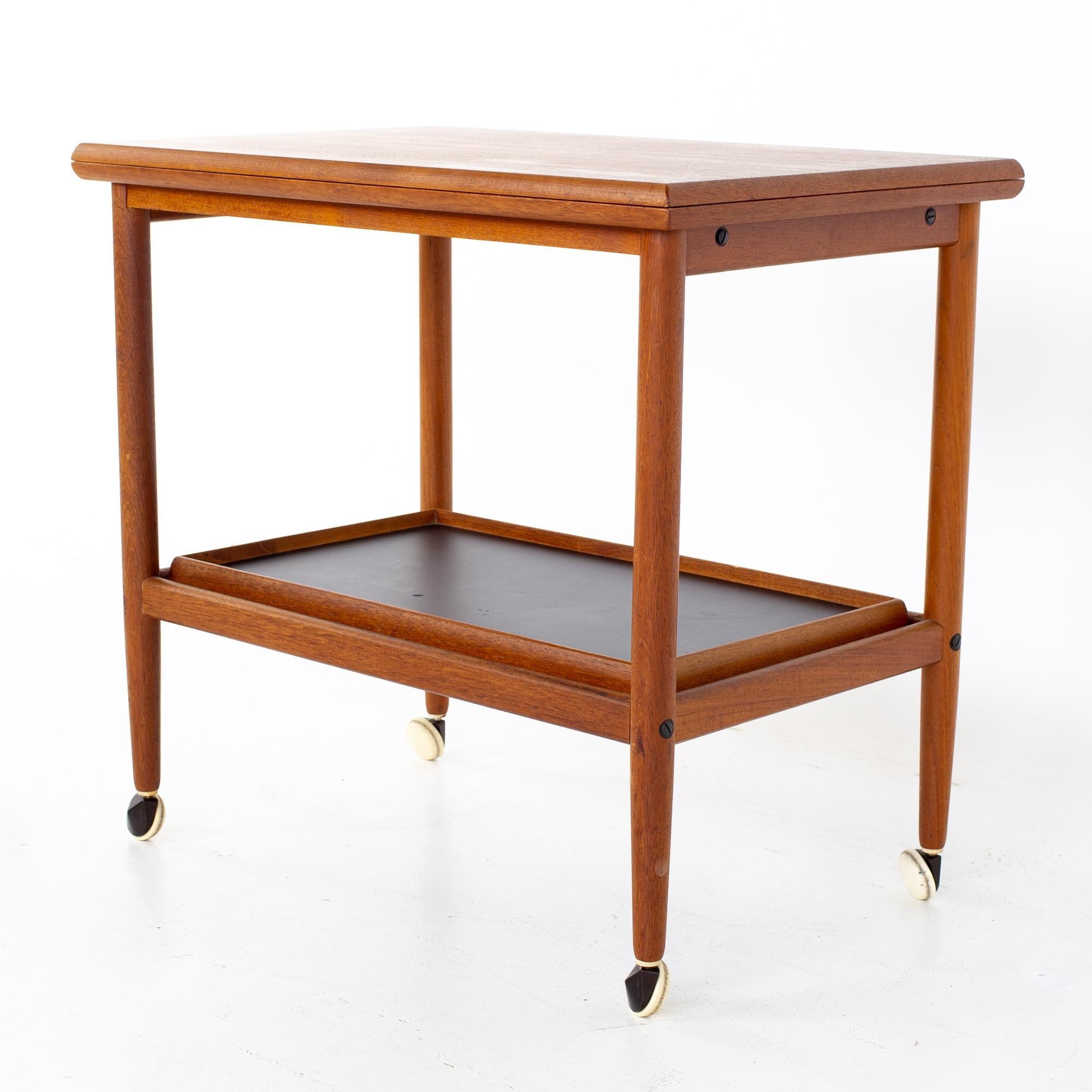 Grete Jalk mid century Danish teak bar cart
When folded, the bar cart measures: 27.5 wide x 17.25 deep x 25 inches high. When expanded, the bar cart measures: 35 wide x 27.75 deep x 25 inches high

All pieces of furniture can be had in what we