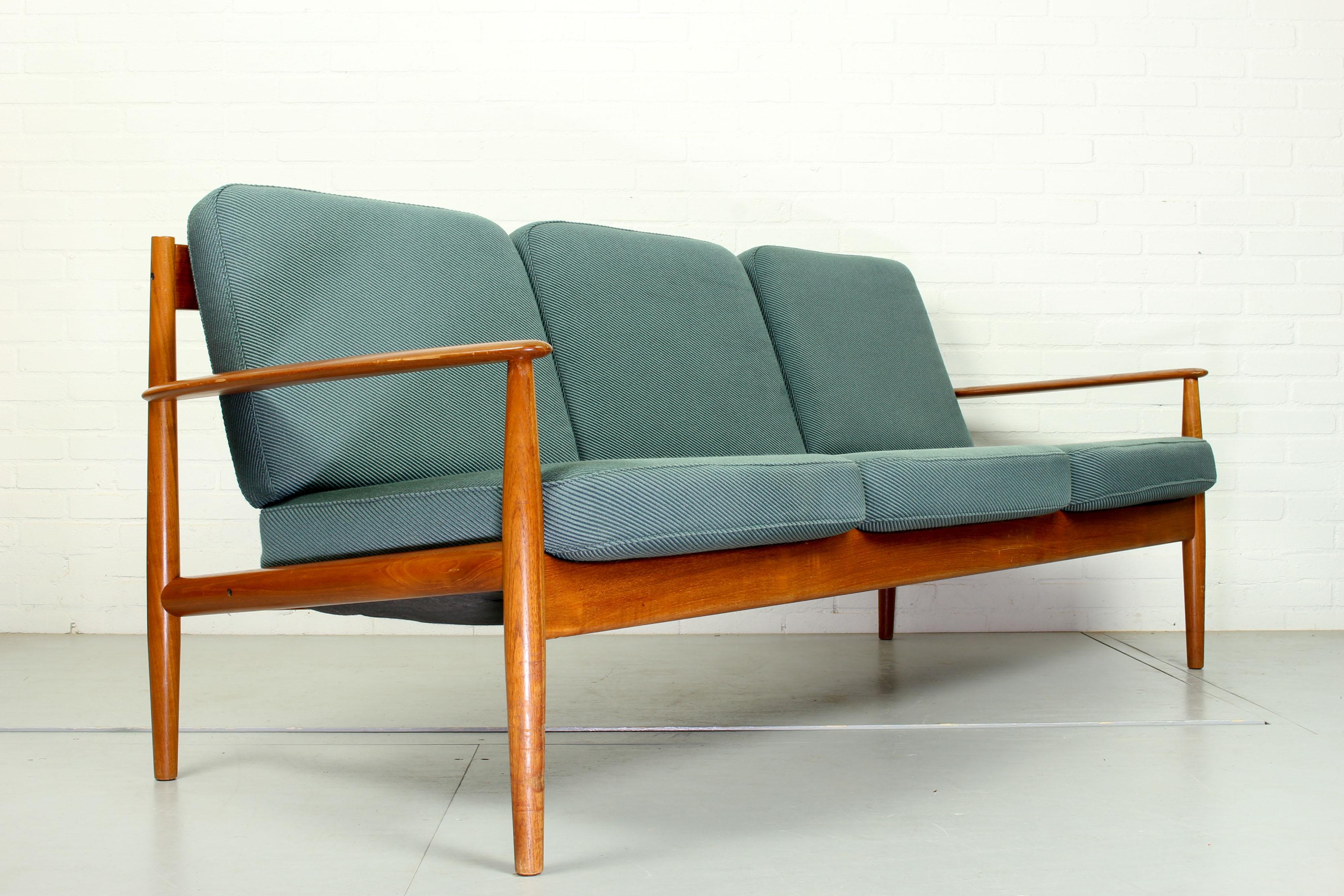 Scandinavian Mid-Century Modern design three-seat teak sofa designed by Grete Jalk for France & Son Denmark, 1963. Model No: 118-3. Beautifully sculpted teak frame. The blue/grey color cushions are in good condition. Originally marked as shown on