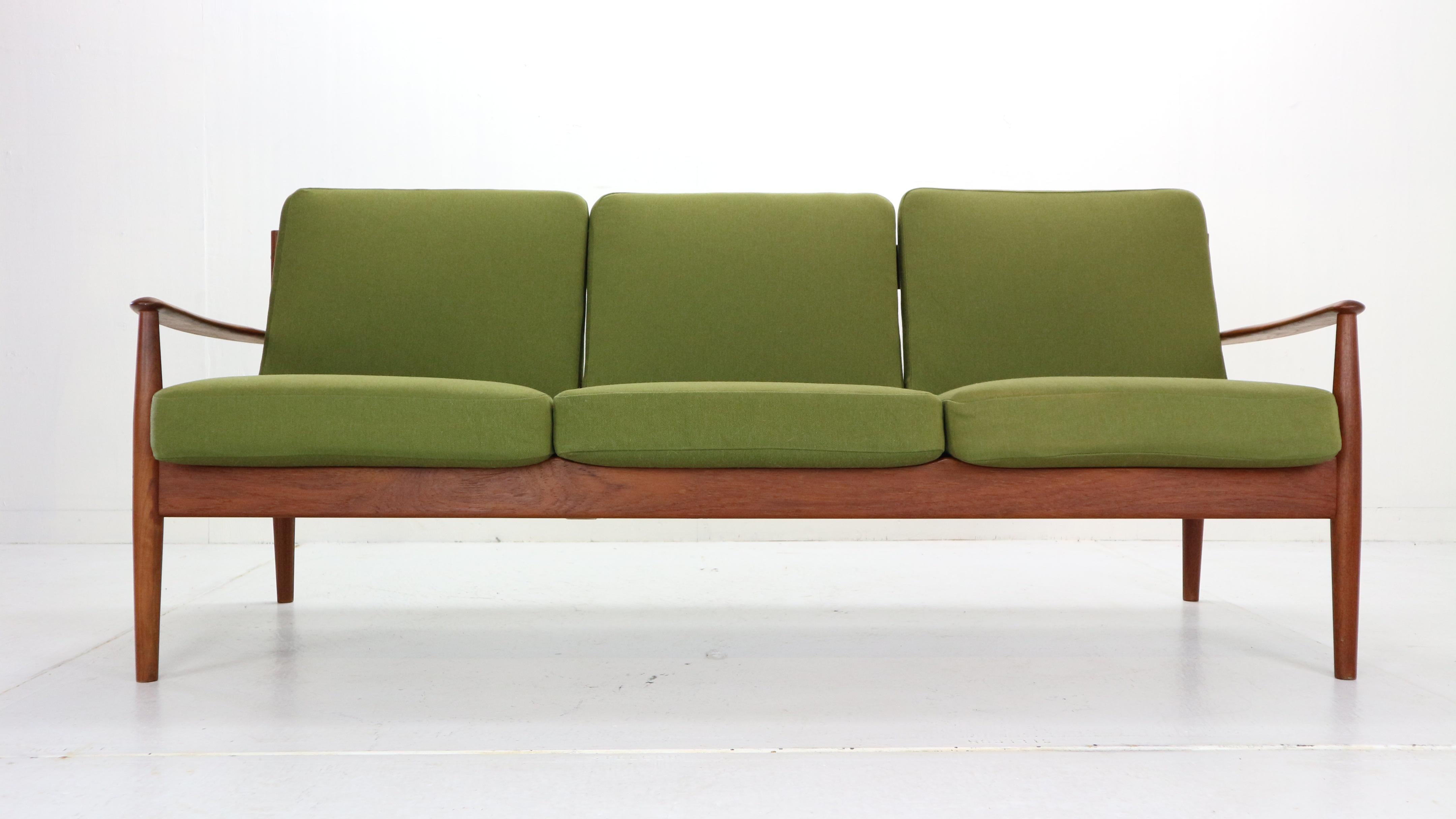 Scandinavian Modern design three-seat sofa designed by Grete Jalk and manufactured for France & Son in 1963, Denmark.
Model No: 118.
Sculpted frame, back and armrests are made from solid teak wood.
The green color cushions are made from high