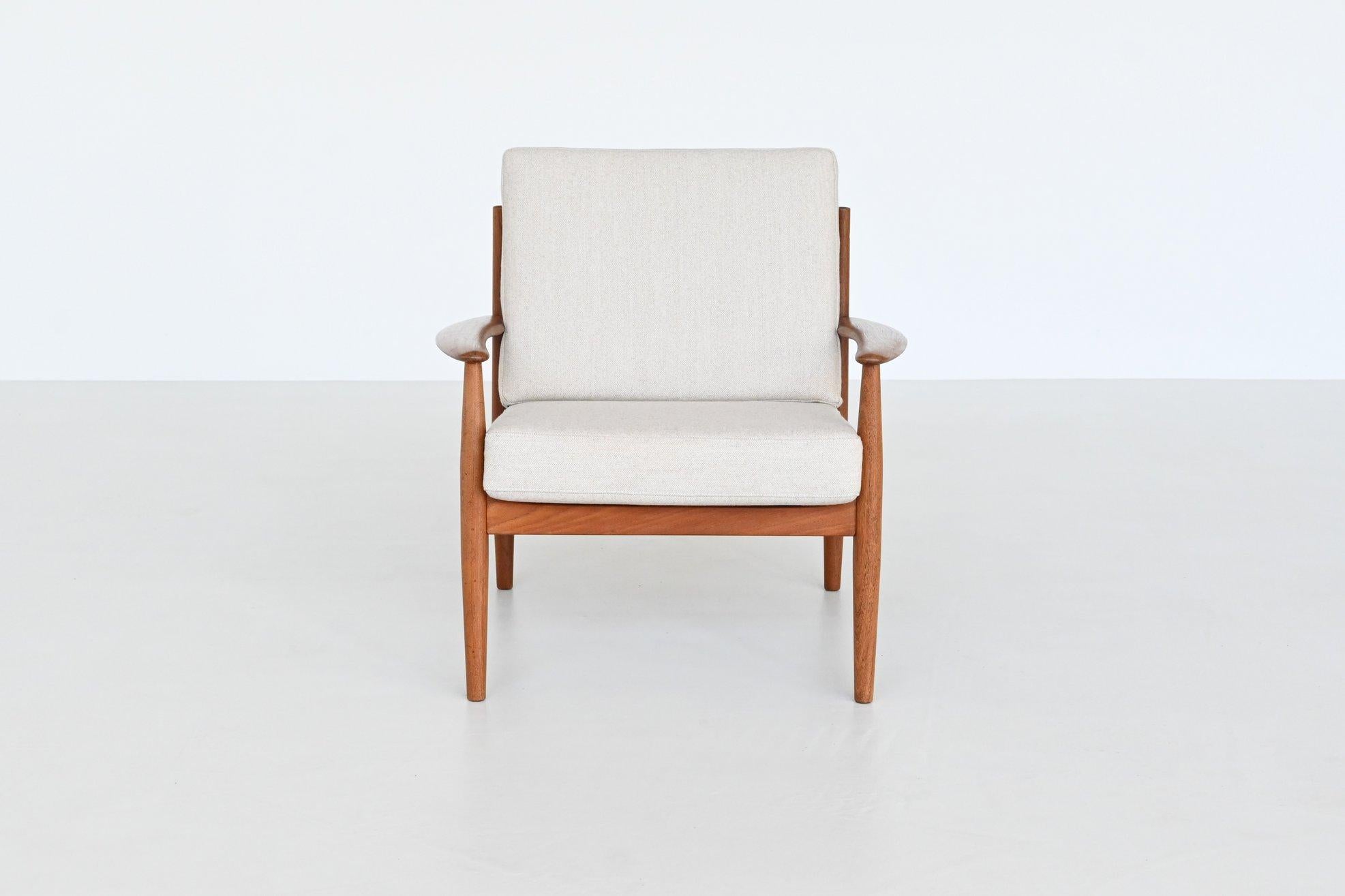 Stunning lounge chair model 128 designed by one of the few female mid-century furniture designers Grete Jalk for France & Søn, Denmark 1960. This elegant shaped lounge chair is handcrafted in solid teak wood and the new cushions are newly