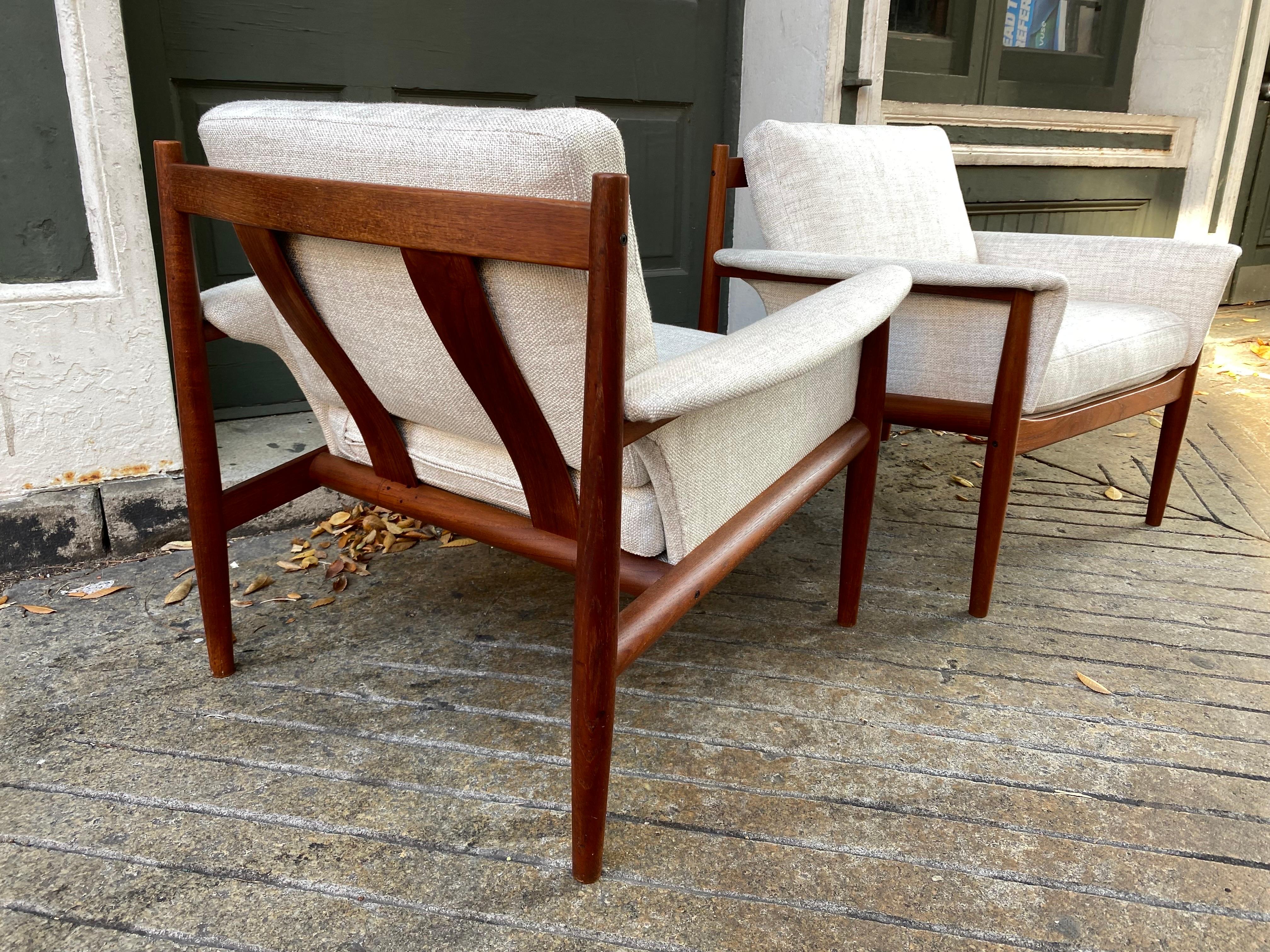 Grete Jalk for France & Daverkosen teak PAIR of lounge chairs. Newly reupholstered with all metal inner coil springs still present and in great shape. Beautiful Teak with attention to detail! Nice concave caps to tops of wood as seen in photos. Very