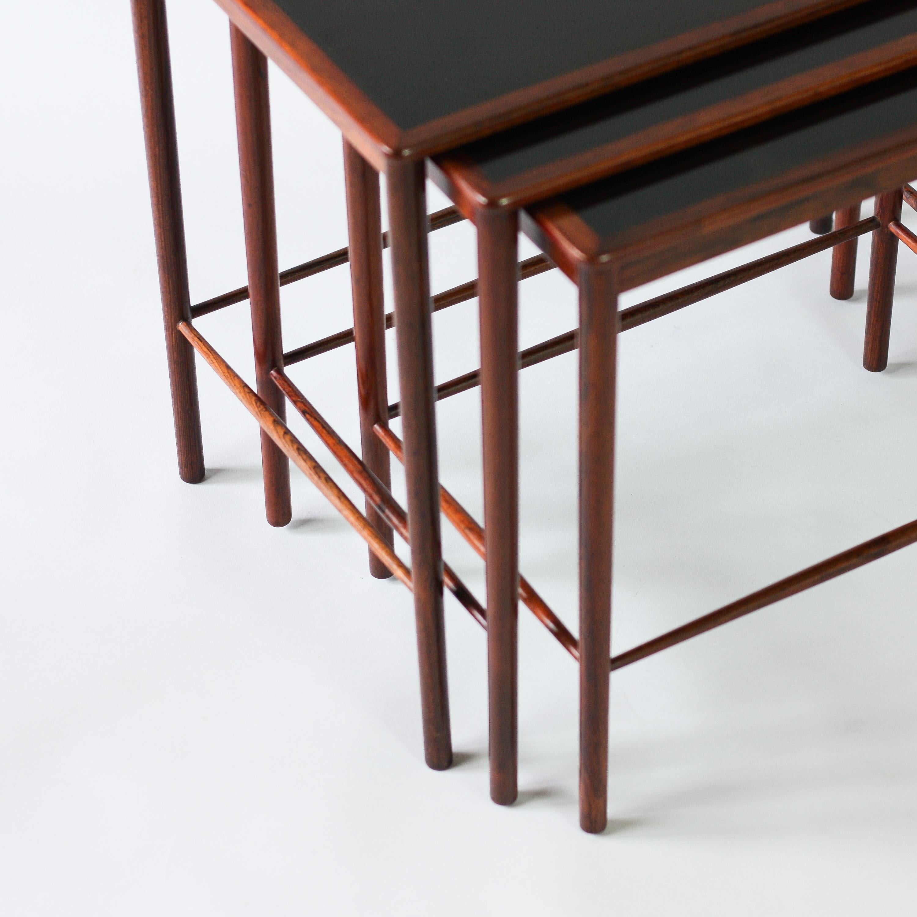 Set of rosewood nesting tables by Grete Jalk for Poul Jeppesens Møbelfabrik, 1960s. The finesse of this nest of tables is remarkable. Rosewood with polished formica tops. The tables have been beautifully restored without concealing age and patina,
