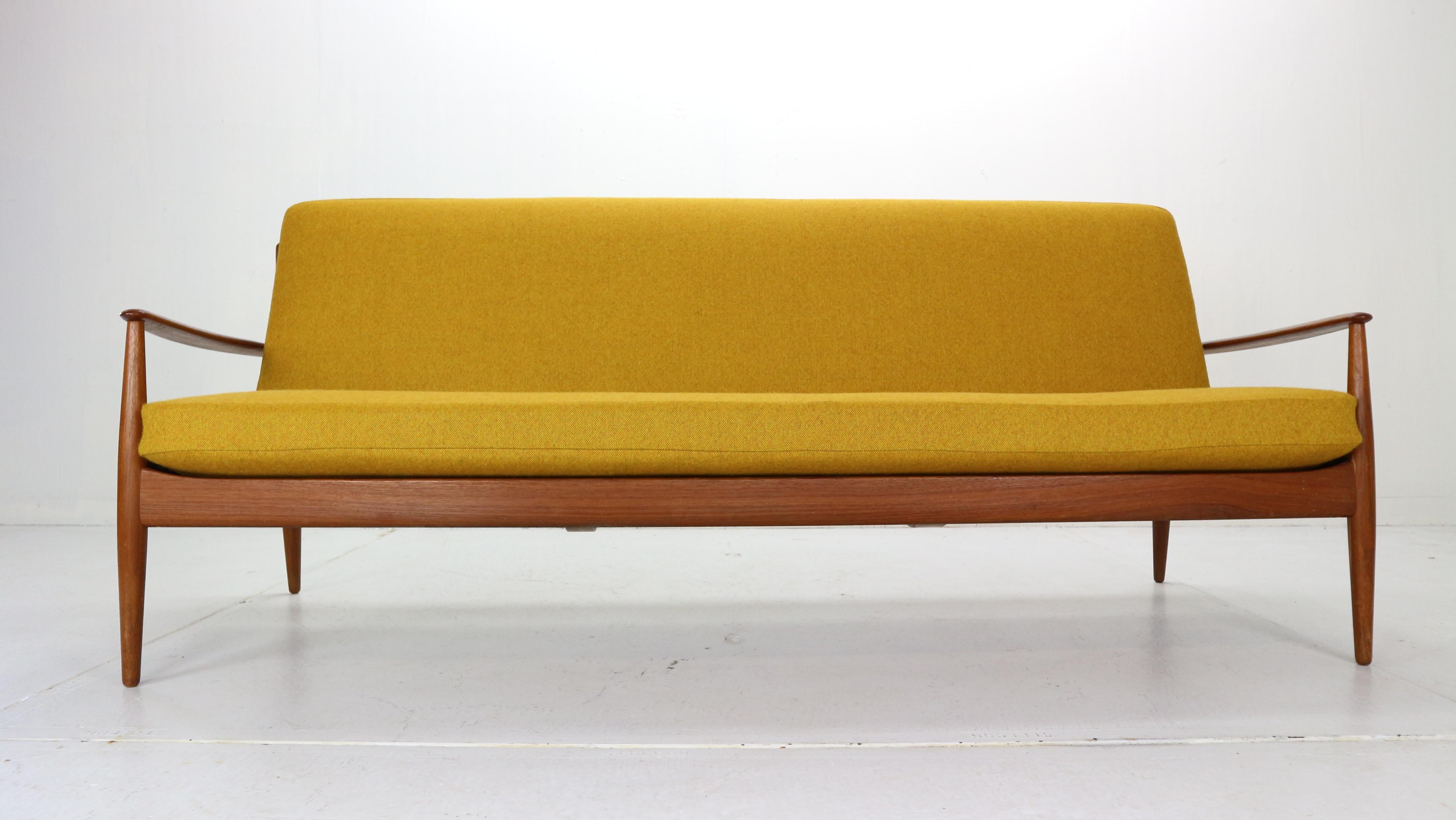 Scandinavian Modern design three-seat sofa designed by Grete Jalk and manufactured for France & Son in 1963, Denmark.

Sculpted frame, back and armrests are made from solid teak wood.
The yellow color seating and back rest has been newly