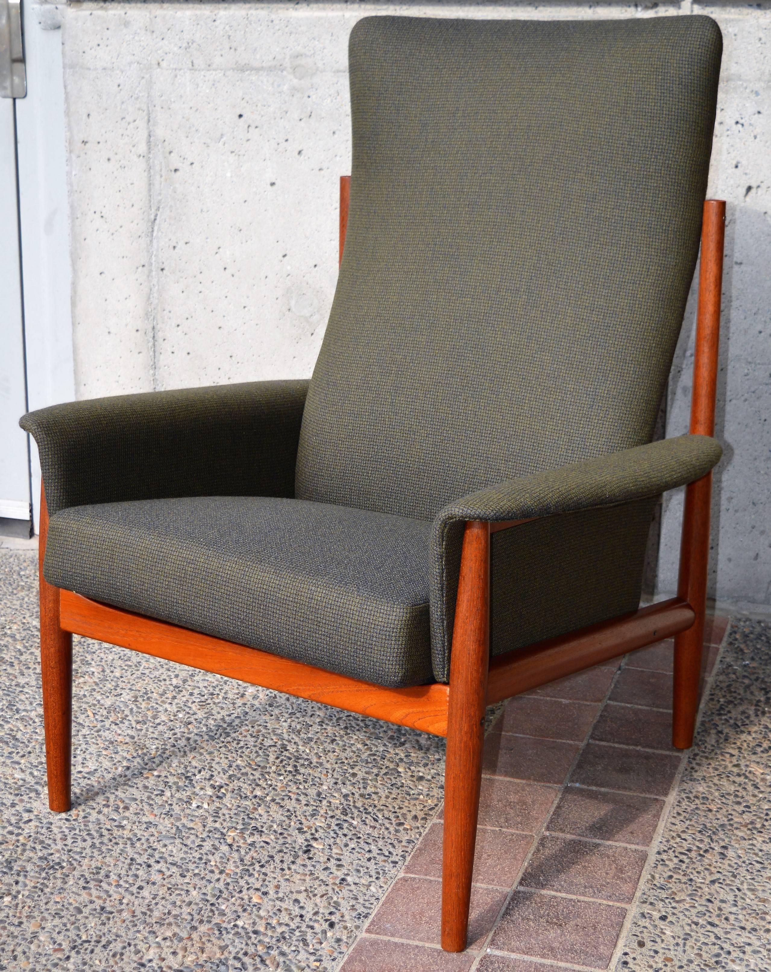 This phenomenal Danish modern rare teak tall back lounge chair was designed by Grete Jalk in the 1960s and manufactured by France & Son. Featuring beautifully contoured upholstered armrests, a thin profile sprung backrest that contours for lumbar