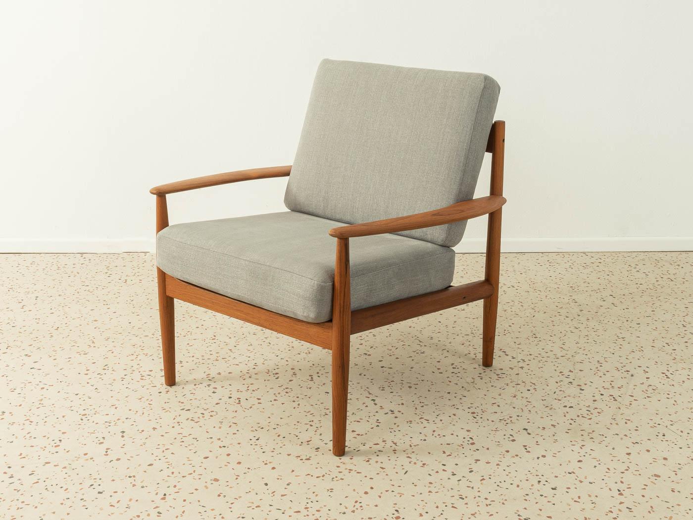 Classic armchair by Grete Jalk for Cado. High-quality solid wood frame made of teak. The original spring cores of the seat and backrest have been reupholstered and covered with a high-quality grey upholstery fabric.

Quality Features:
- very good