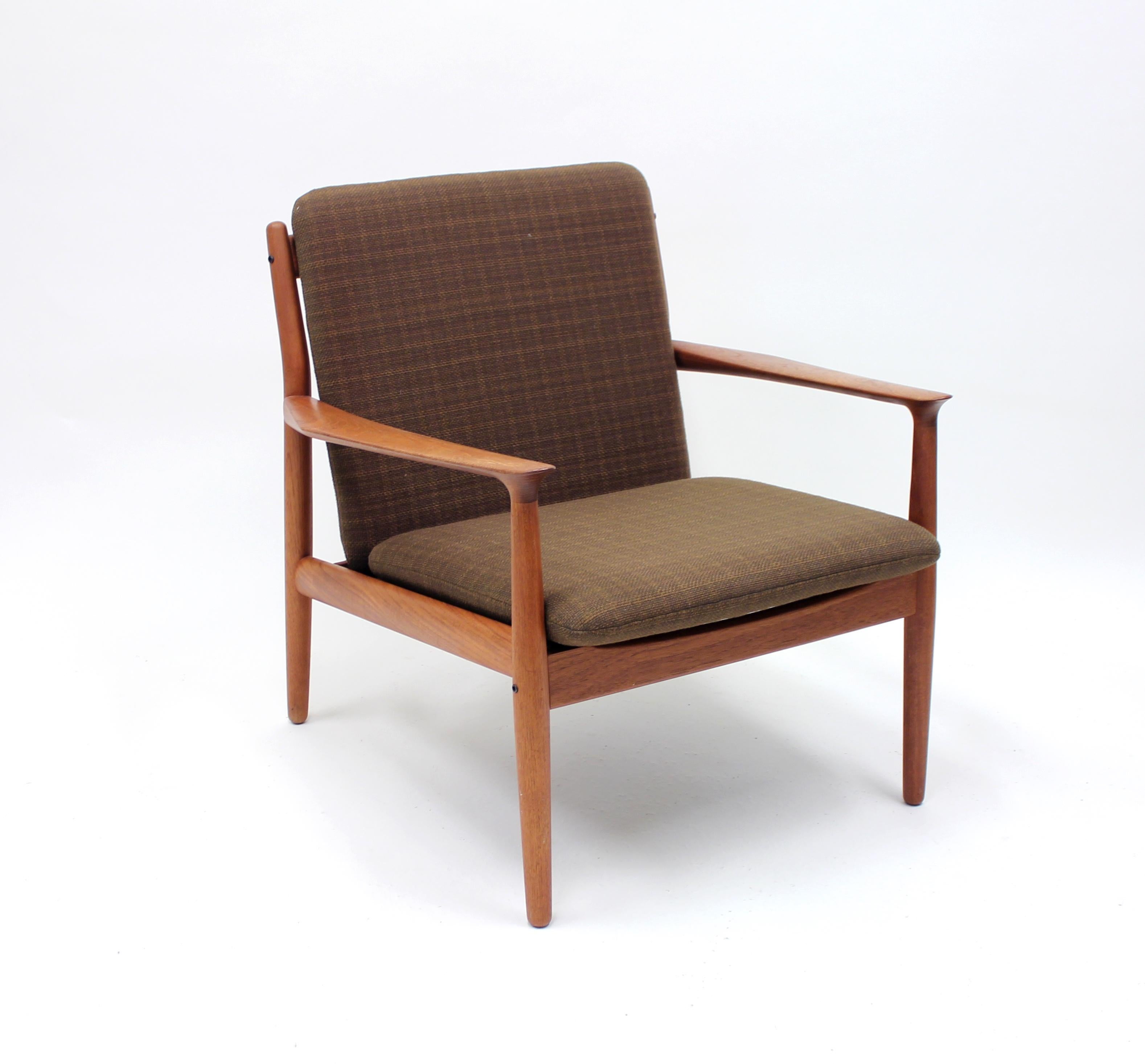Danish teak lounge chair designed by Grete Talk for Glostrup Møbelfabrik in the 1950s. Very good condition with the original brown or green fabric. Marked with makers mark on the frame.