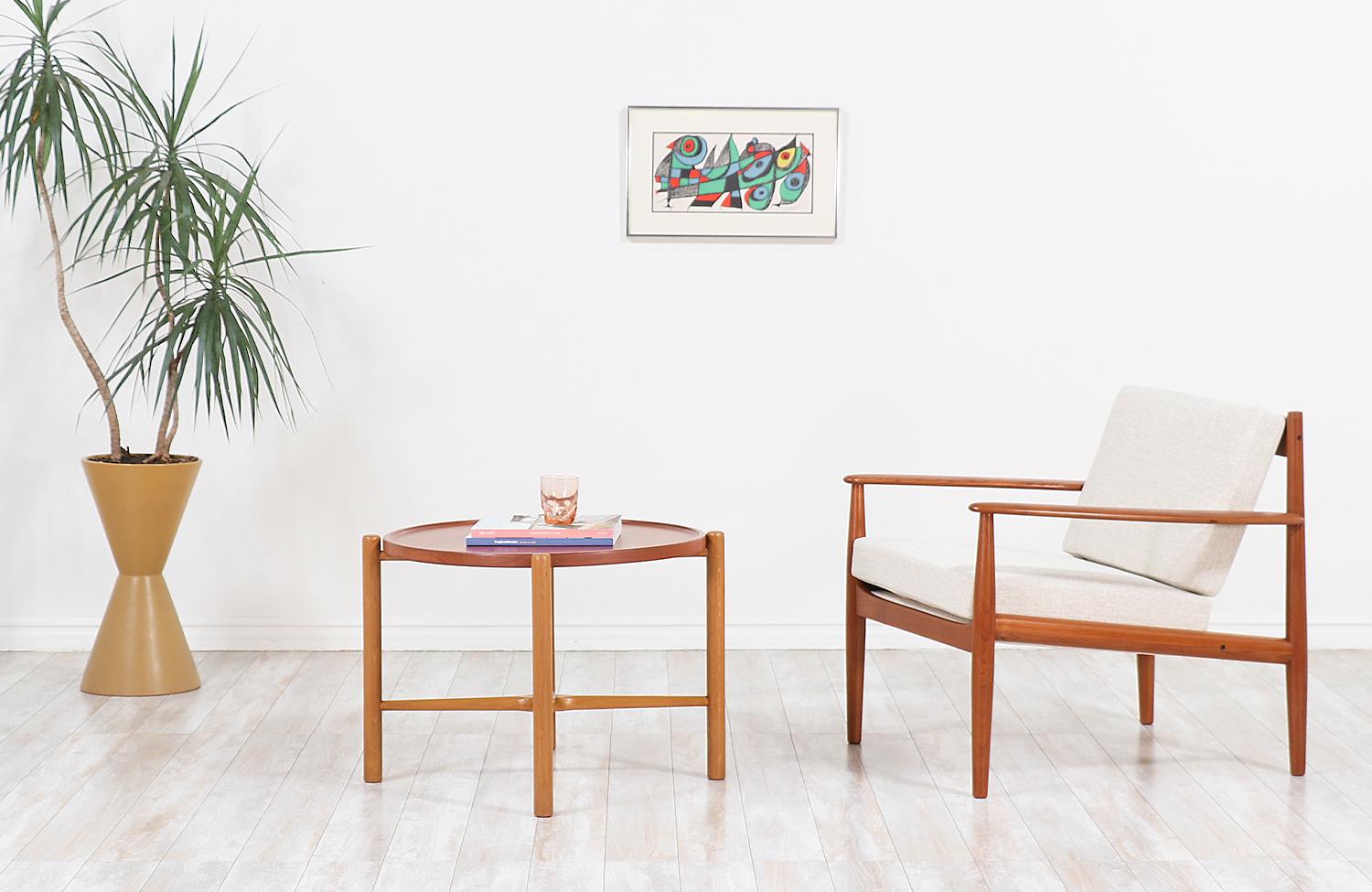 Elegant lounge chair designed by one of the few female midcentury furniture designers, Grete Jalk. This example was designed in collaboration with the Danish company France & Søn in Denmark in the 1960s. Handcrafted in solid teak wood, it features