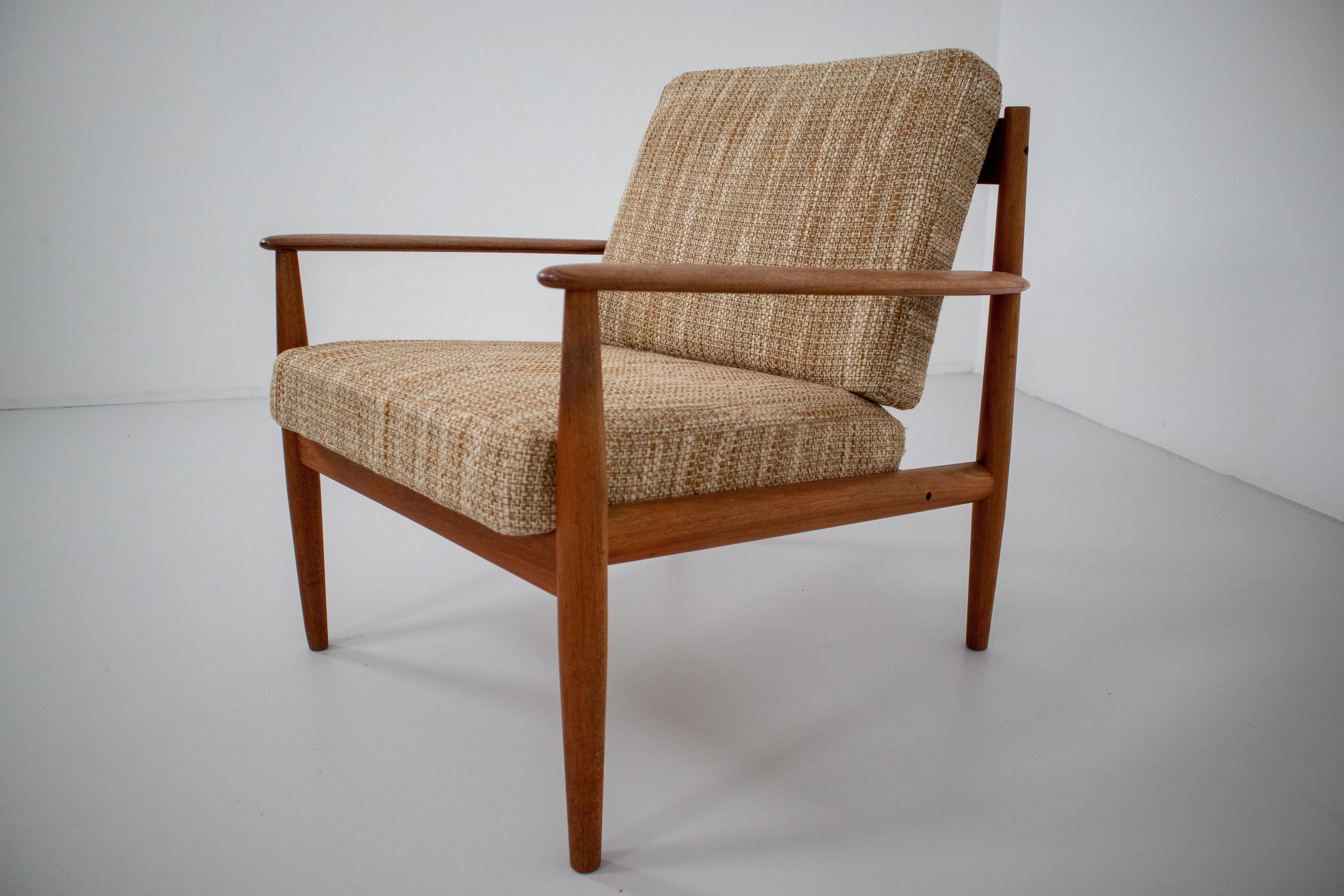 Elegant lounge chair designed by one of the few female Mid Century furniture designers, Grete Jalk, in Denmark for France & Søn c. 1960’s. Constructed of teak wood and Cushions are original and sprung, fabric also original and in very good