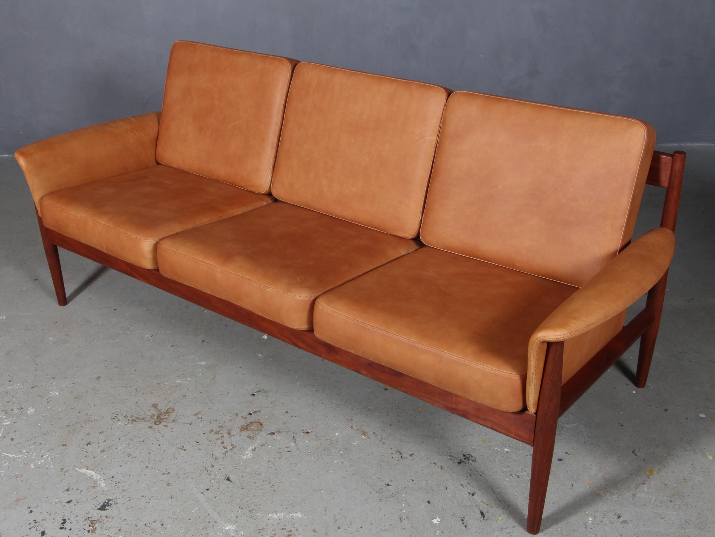 Grete Jalk three seat sofa.

New upholstered cushions with tan aniline leather.

Made by France & Daverkosen.