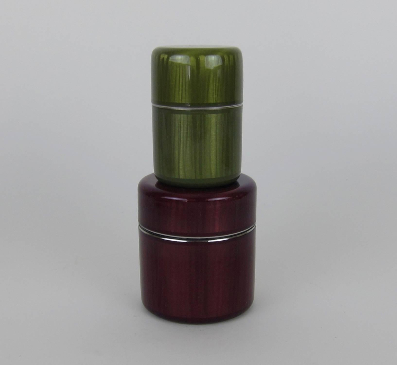 An award-winning set of two of midcentury covered canister boxes designed by Grete Prytz Kittelsen (1917–2010) for Cathrineholm of Norway in 1955. This Kittelsen / Cathrineholm collaboration was awarded a Gold Medal at the Milan Triennale IX in