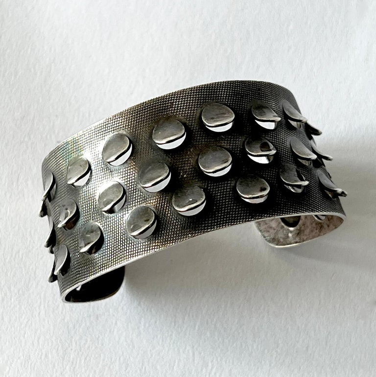 A sterling silver bracelet with punched out 'scales' created by Norwegian goldsmith and enamelist Grete Prytz Kittelsen.  Bracelet measures 1 3/8