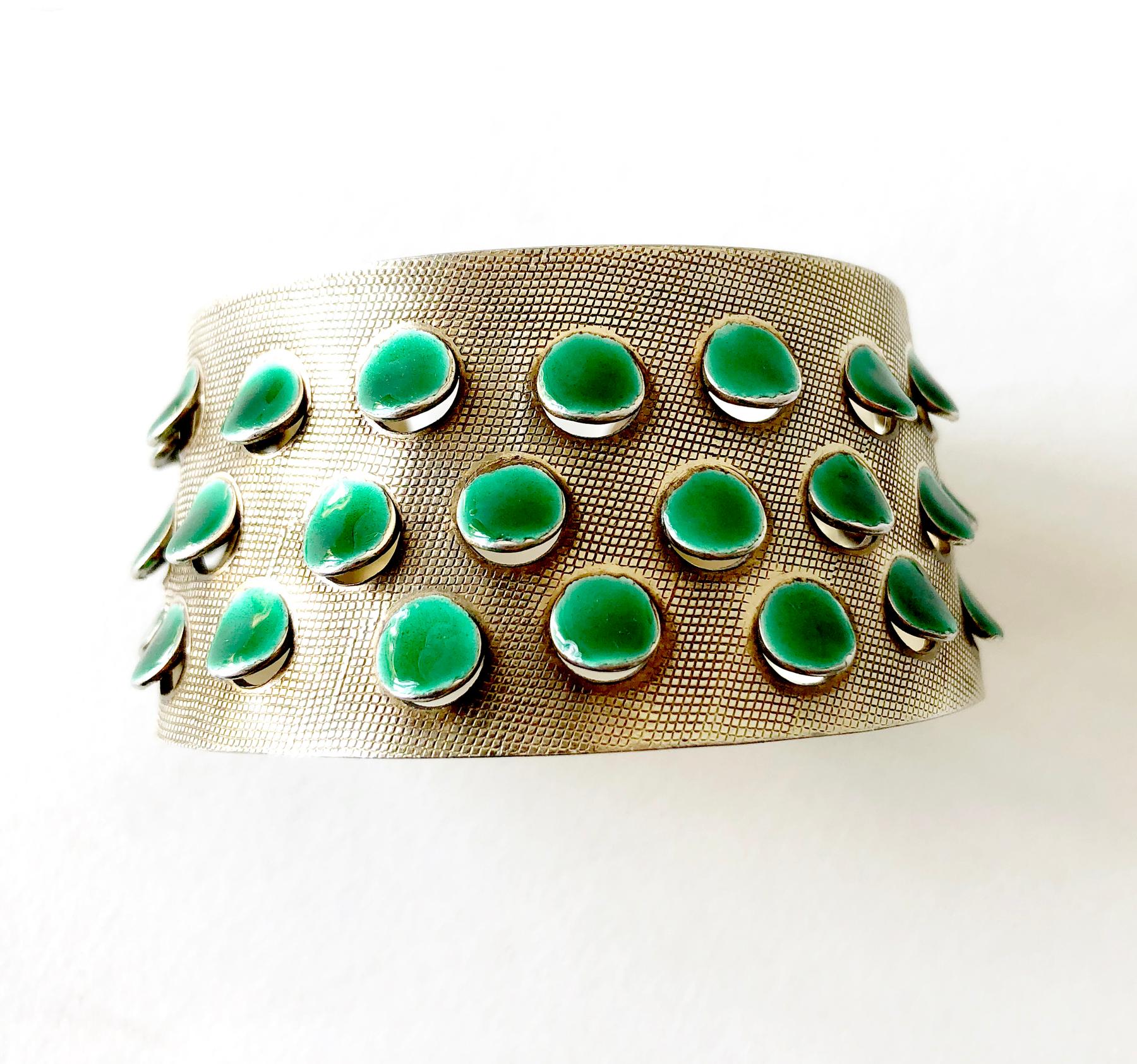 Iconic, lightly gold plated sterling silver bracelet with emerald green enameled scales or tabs created by Grete Prytz Kittelsen of Oslo, Norway.  Bracelet measures 1 3/8