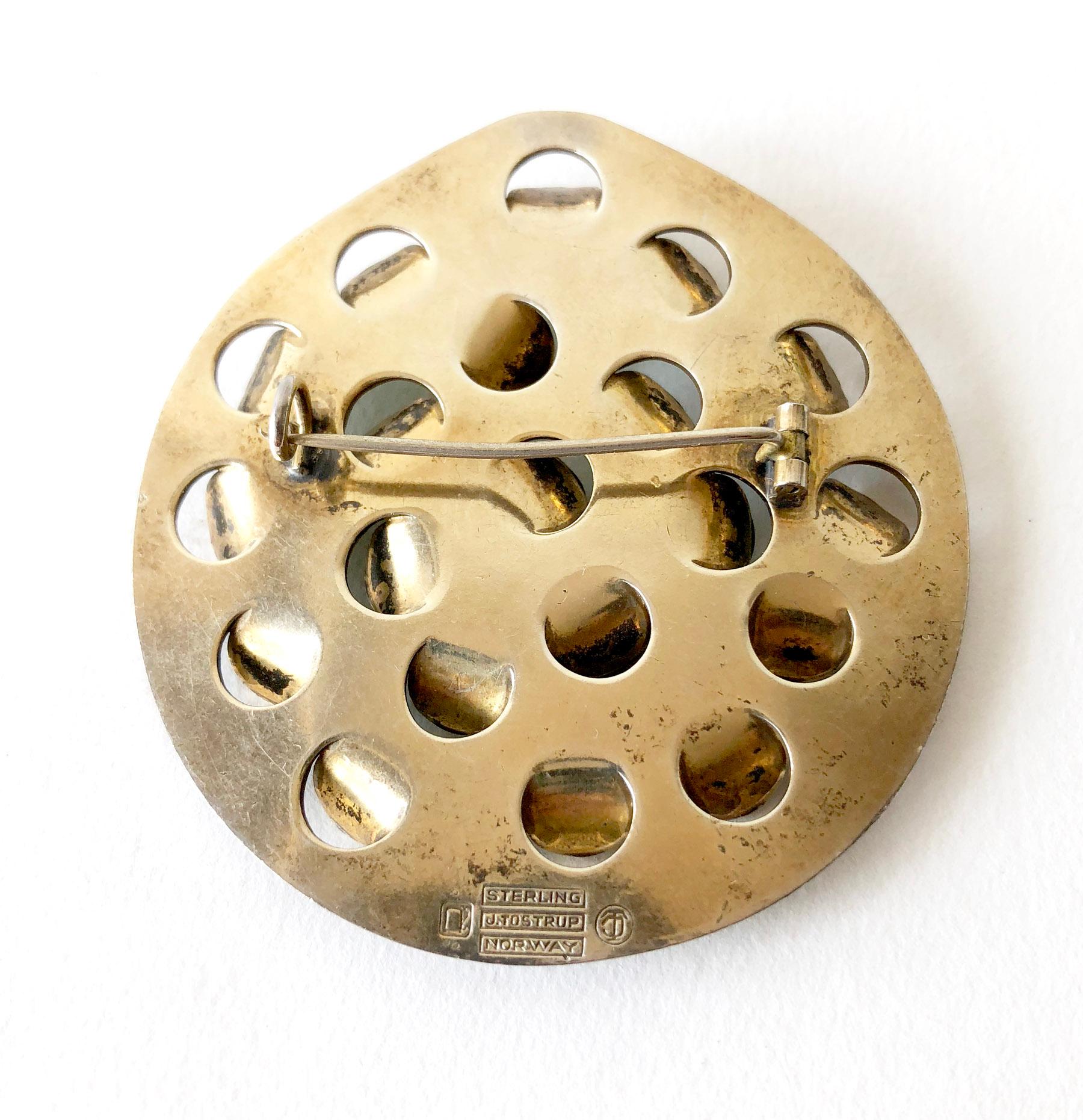 Iconic, lightly gold plated sterling silver brooch with emerald green enameled scales or tabs created by Grete Prytz Kittelsen of Oslo, Norway.  Brooch measures 2.25