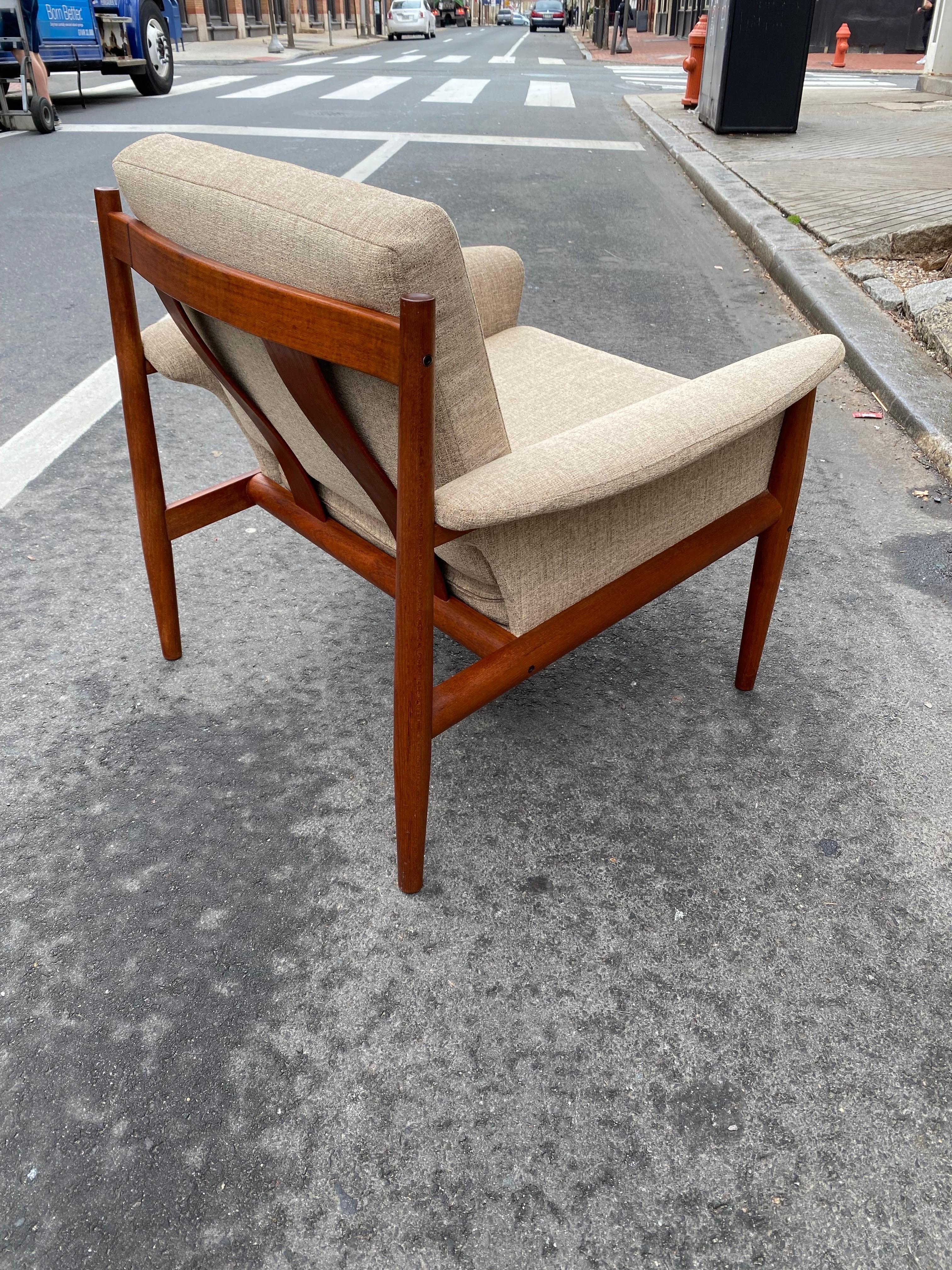 Grete Jalk for France & Daverkosen teak lounge chair. Newly reupholstered with all metal inner coil spring still present and in great shape. Beautiful Teak with attention to detail! Nice concave caps to tops of wood as seen in photos. Photos of both