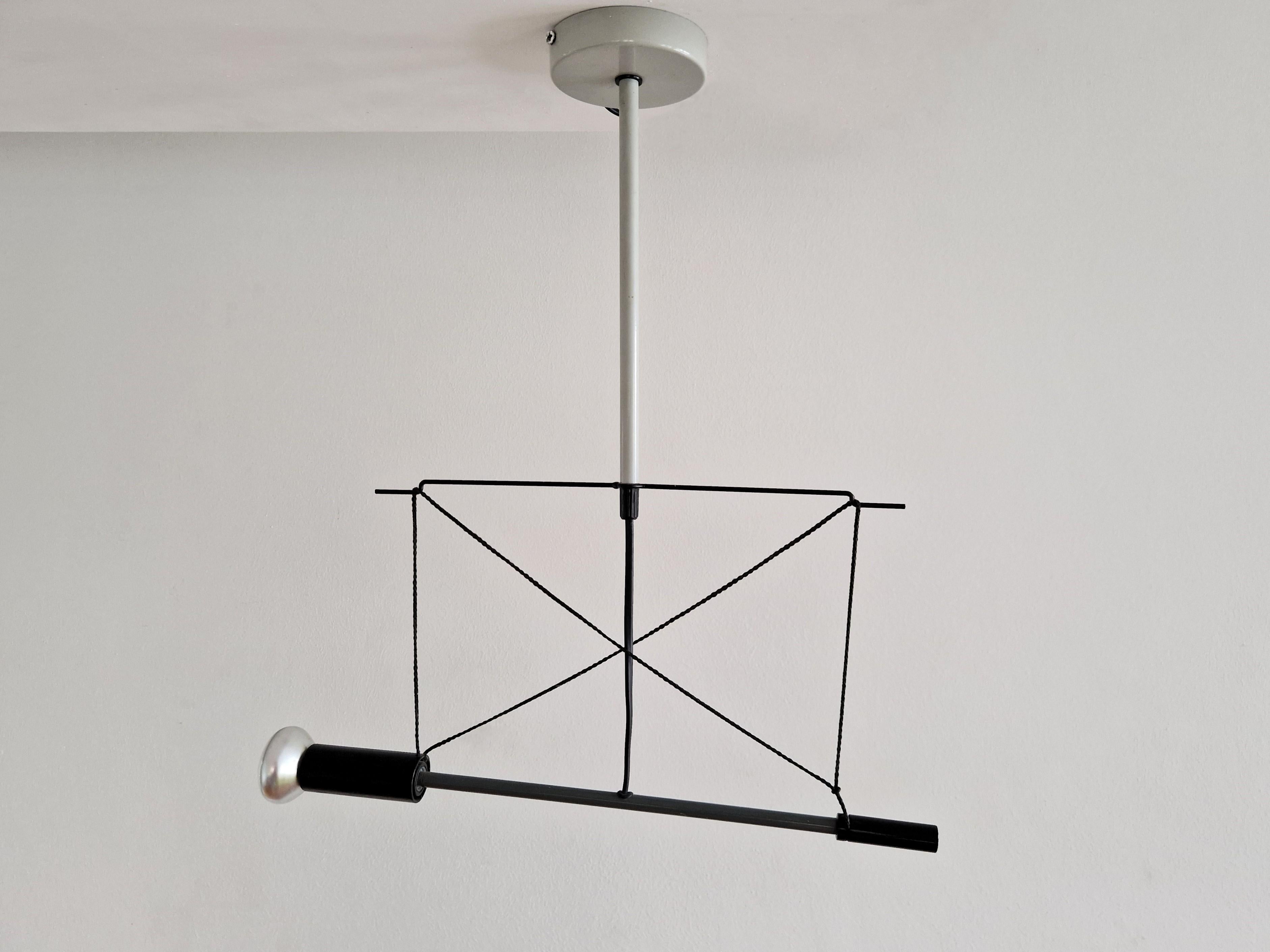 This ceiling lamp, model Spot Torch ST' was designed by Herman Hermsen for Designum in 1982. It is made out of grey lacquered steel with black accents, aluminum and nylon rope that provides the adjustability of the light. A great piece for