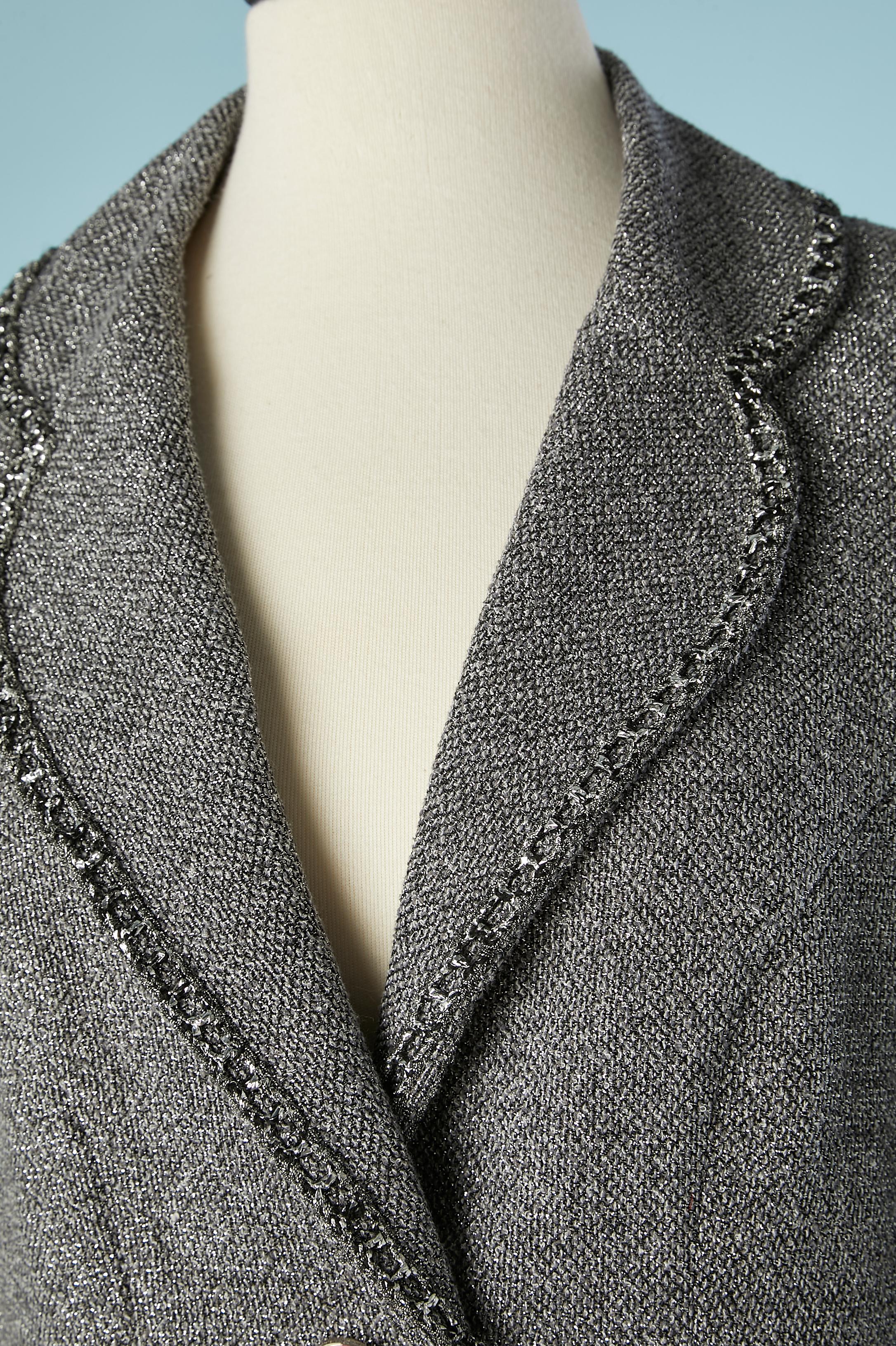 Grey and black tweed lurex double-breasted jacket.Raglan. Branded buttons in the middle front and cuffs. Fabric composition: 49% cotton, 31% rayon, 12% polyester, 8% polyamide. Silk branded lining. 
SIZE 42 (Fr) 12 (Us)