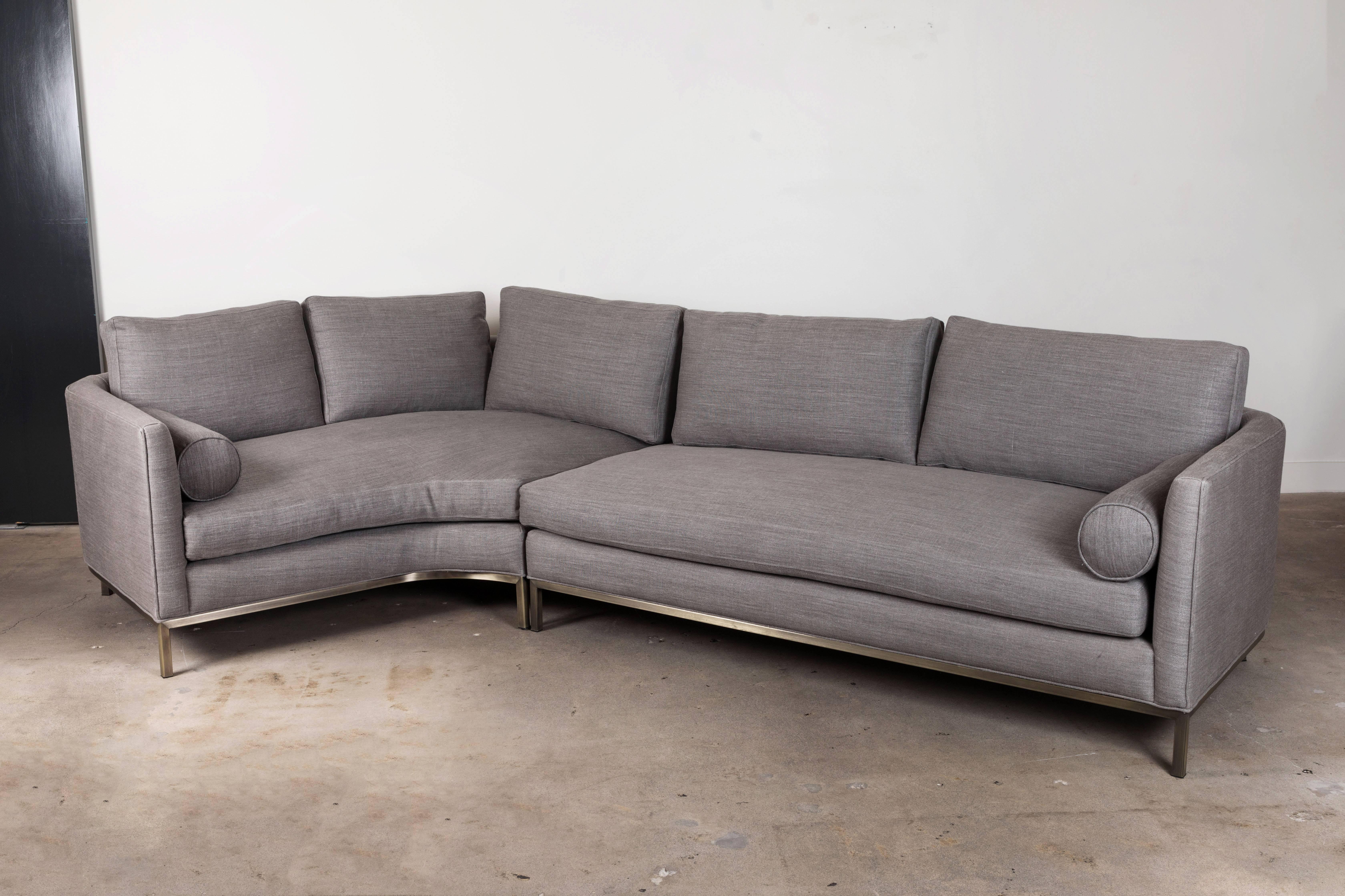 The curved back sectional is a tuxedo style sofa with curved back corners and features down-wrapped, removable seat and back cushions and two bolsters. Can be made with a white oak, American walnut, or metal base.

The Lawson-Fenning collection is