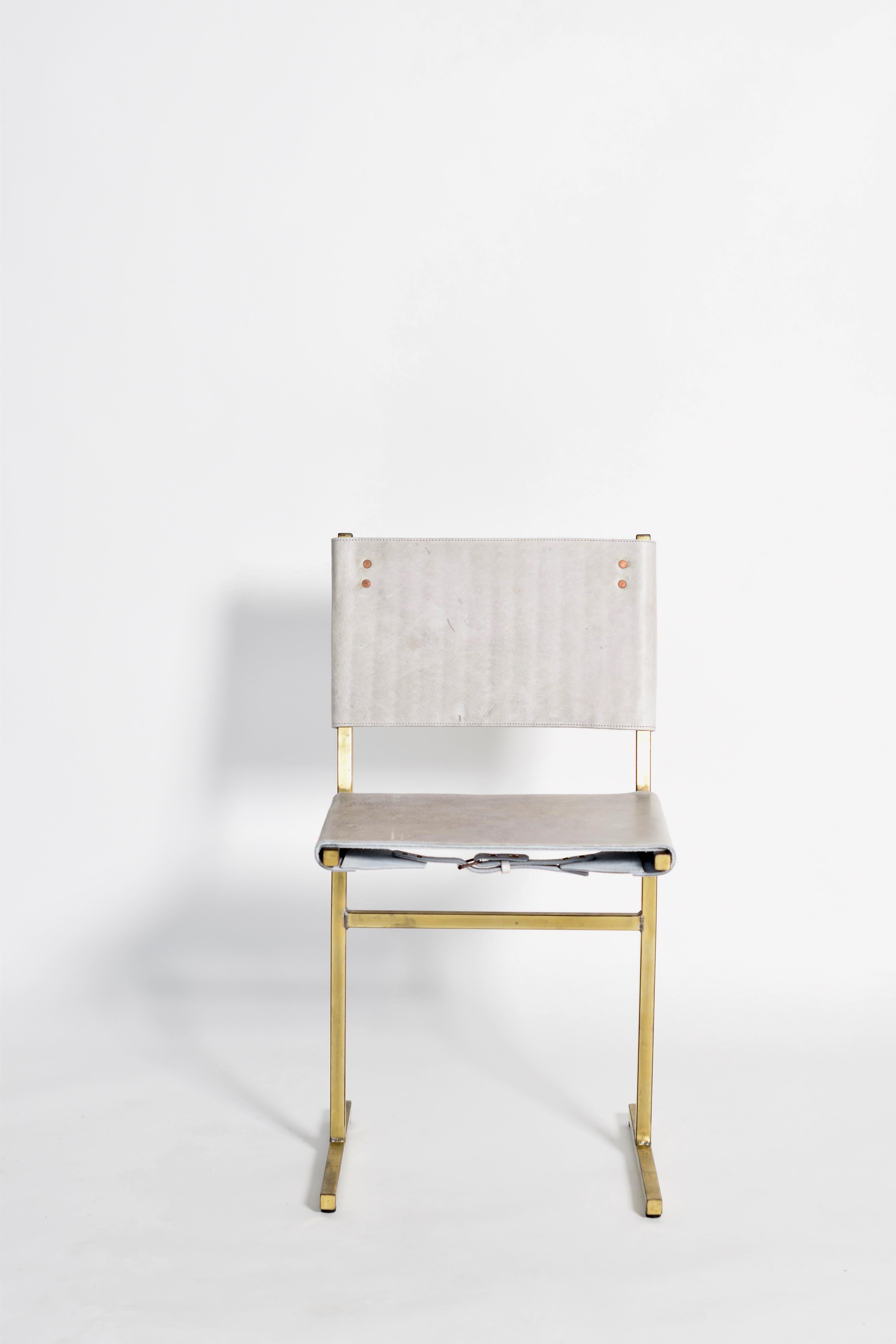 Grey and brass Memento chair, Jesse Sanderson
Original signed chair by Jesse Sanderson
Materials: Leather, Steel
Dimensions: W 43 x D 50 x H 80 cm 
 Seating height: 47 cm

Five lines and a circle – the human body can be as simple as the
