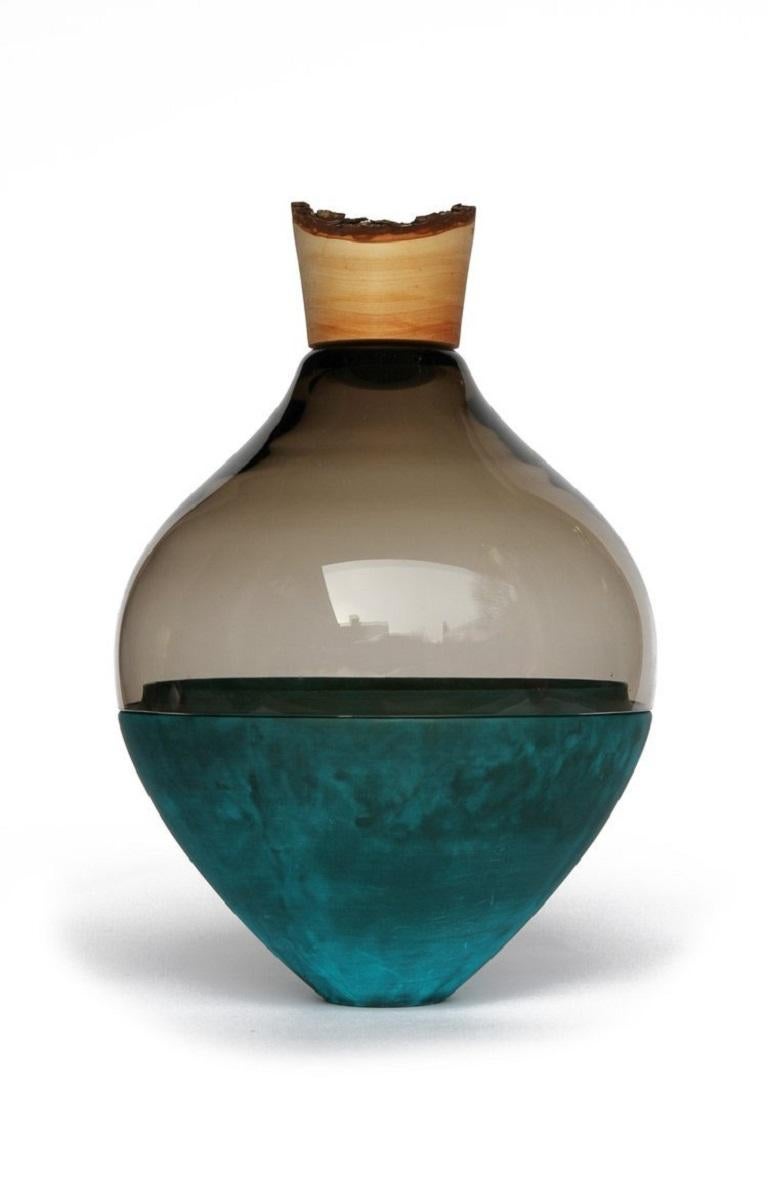 Grey and copper patina India Vessel II, Pia Wüstenberg.
Dimensions: D 20 x H 38.
Materials: glass, wood, copper.
Available in other metals: brass, copper, copper patina, aluminum, rust.

Handmade in Europe, by individual craftsmen: handblown