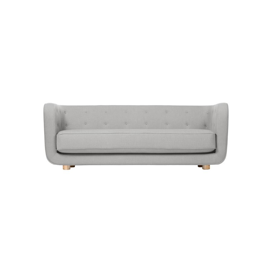Grey and natural oak Raf Simons Vidar 3 Vilhelm sofa by Lassen
Dimensions: W 217 x D 88 x H 80 cm 
Materials: textile, oak.

Vilhelm is a beautiful padded three-seater sofa designed by Flemming Lassen in 1935. A sofa must be able to function in