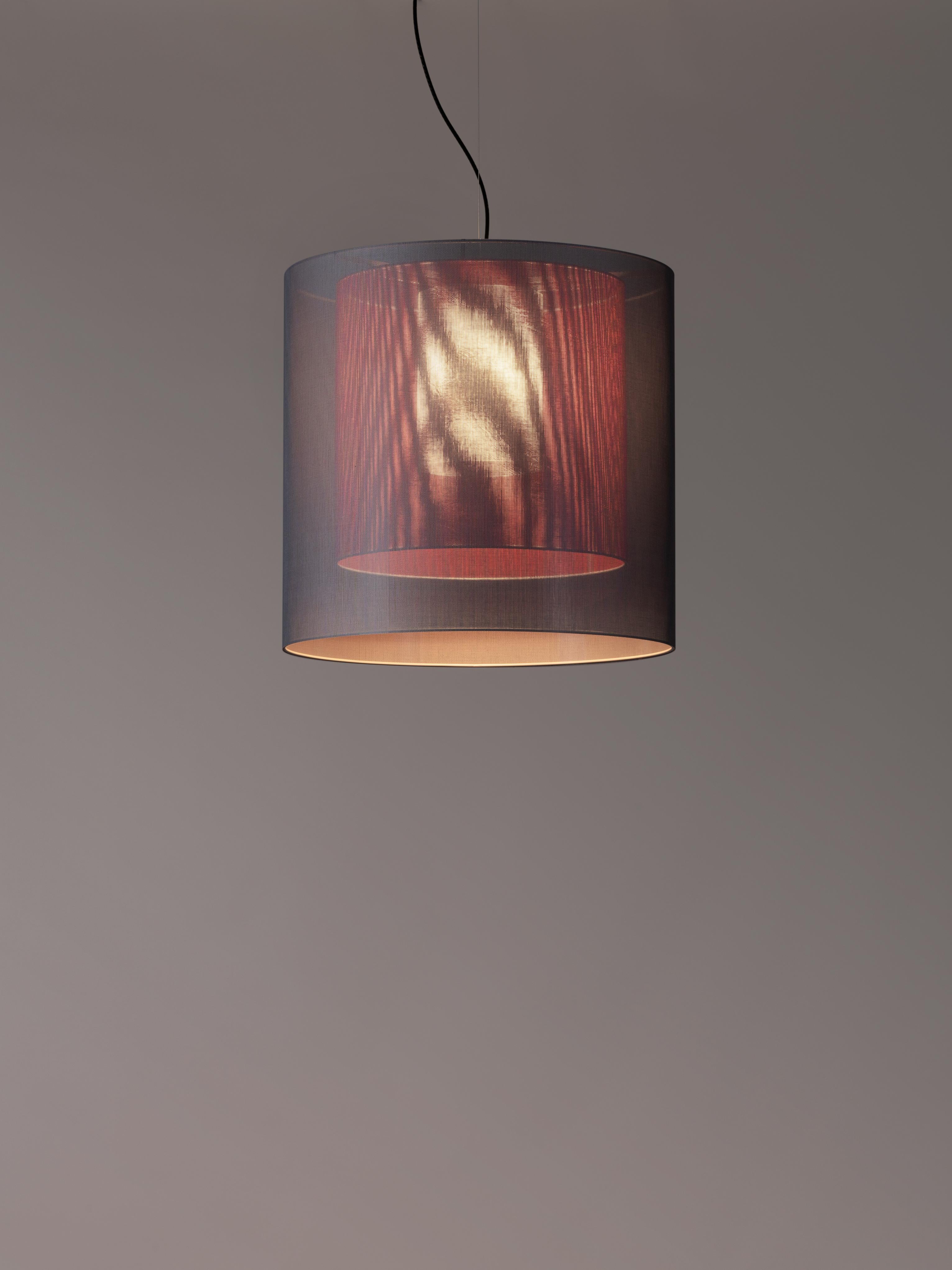 Grey and Red Moaré LM pendant lamp by Antoni Arola
Dimensions: D 62 x H 60 cm
Materials: Metal, polyester.
Available in other colors and sizes.

Moaré’s multiple combinations of formats and colours make it highly versatile. The series takes its