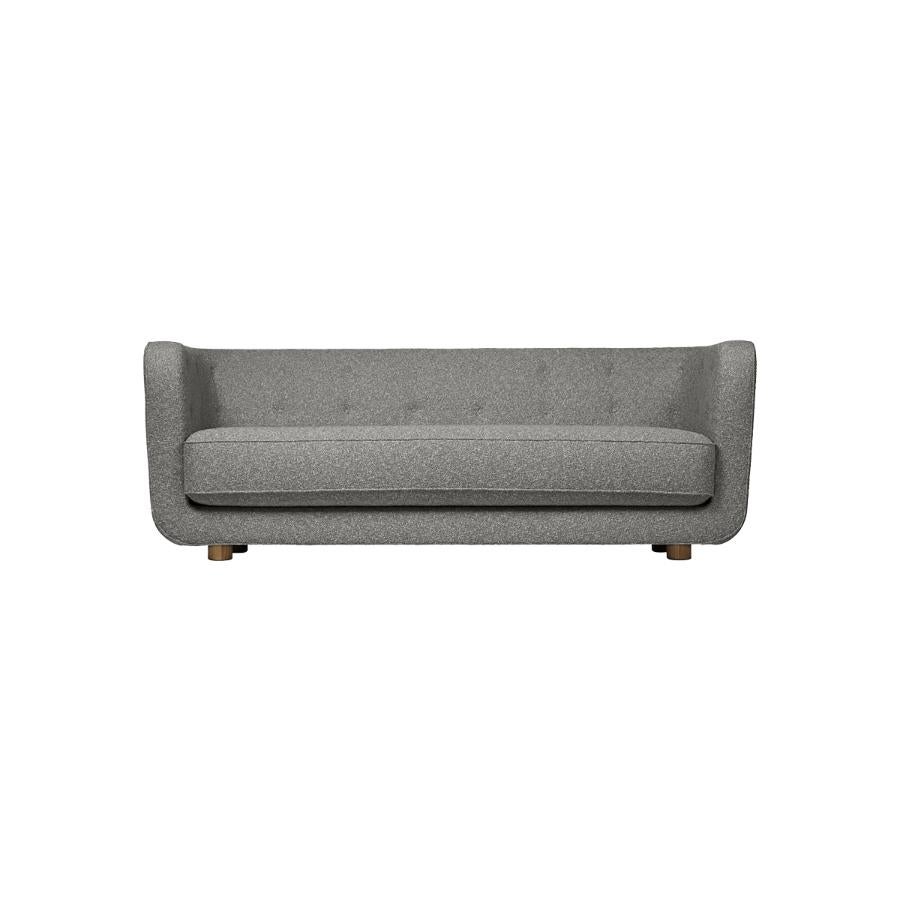 Grey and smoked oak Hallingdal Vilhelm sofa by Lassen
Dimensions: W 217 x D 88 x H 80 cm 
Materials: textile, oak.

Vilhelm is a beautiful padded three-seater sofa designed by Flemming Lassen in 1935. A sofa must be able to function in several