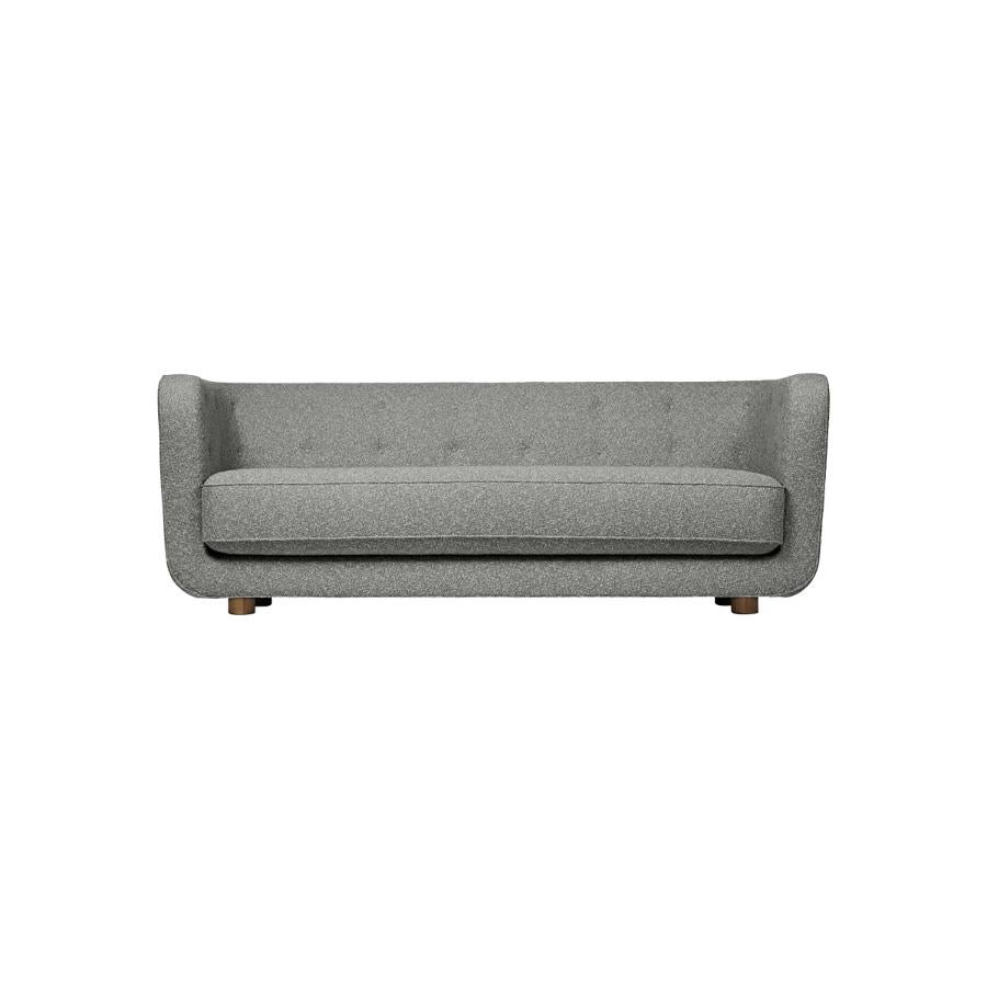 Grey and smoked oak sahco nara vilhelm sofa by Lassen
Dimensions: W 217 x D 88 x H 80 cm 
Materials: textile, oak.

Vilhelm is a beautiful padded three-seater sofa designed by Flemming Lassen in 1935. A sofa must be able to function in several