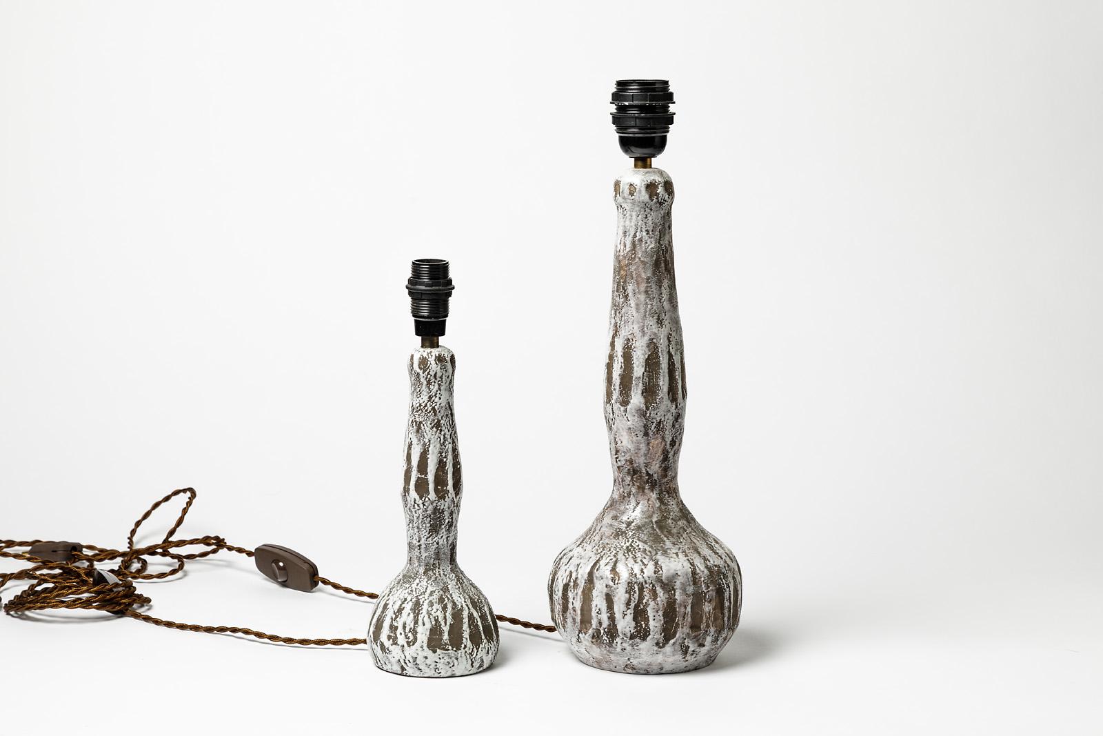 Pair of grey and white ceramic table lamps

An elegant set of two lamps designed, circa 1970s.

Excellent original conditions. New electrical system.

Ceramic dimensions of each: 36 x 15 x 15cm and 24 x 10 x 10cm
With electrical system 43 x