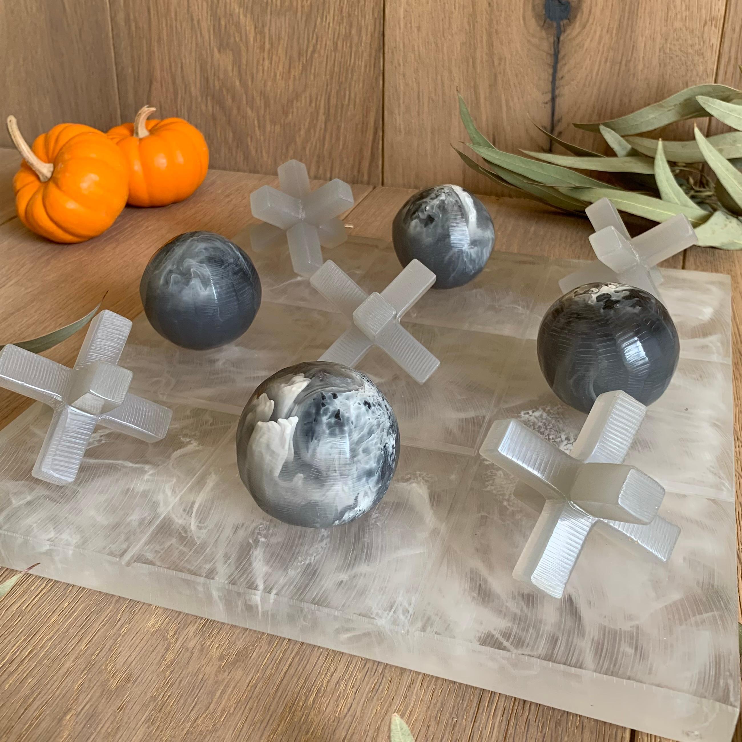 Our Tic Tac Toe is a beautiful, modern and fun take on the classic game. The three dimensional pieces are handmade in grey with white marble textured resin, and board is in clear and white marble texture resin. It will be the coolest statement piece