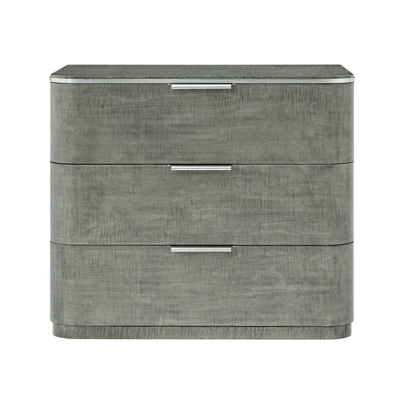 This elegant piece showcases a stunning combination of layered oak, stainless steel, and maple veneers, making it a refined addition to any bedroom decor. The Pebble Grey finish adds a touch of modern while highlighting the natural beauty of the