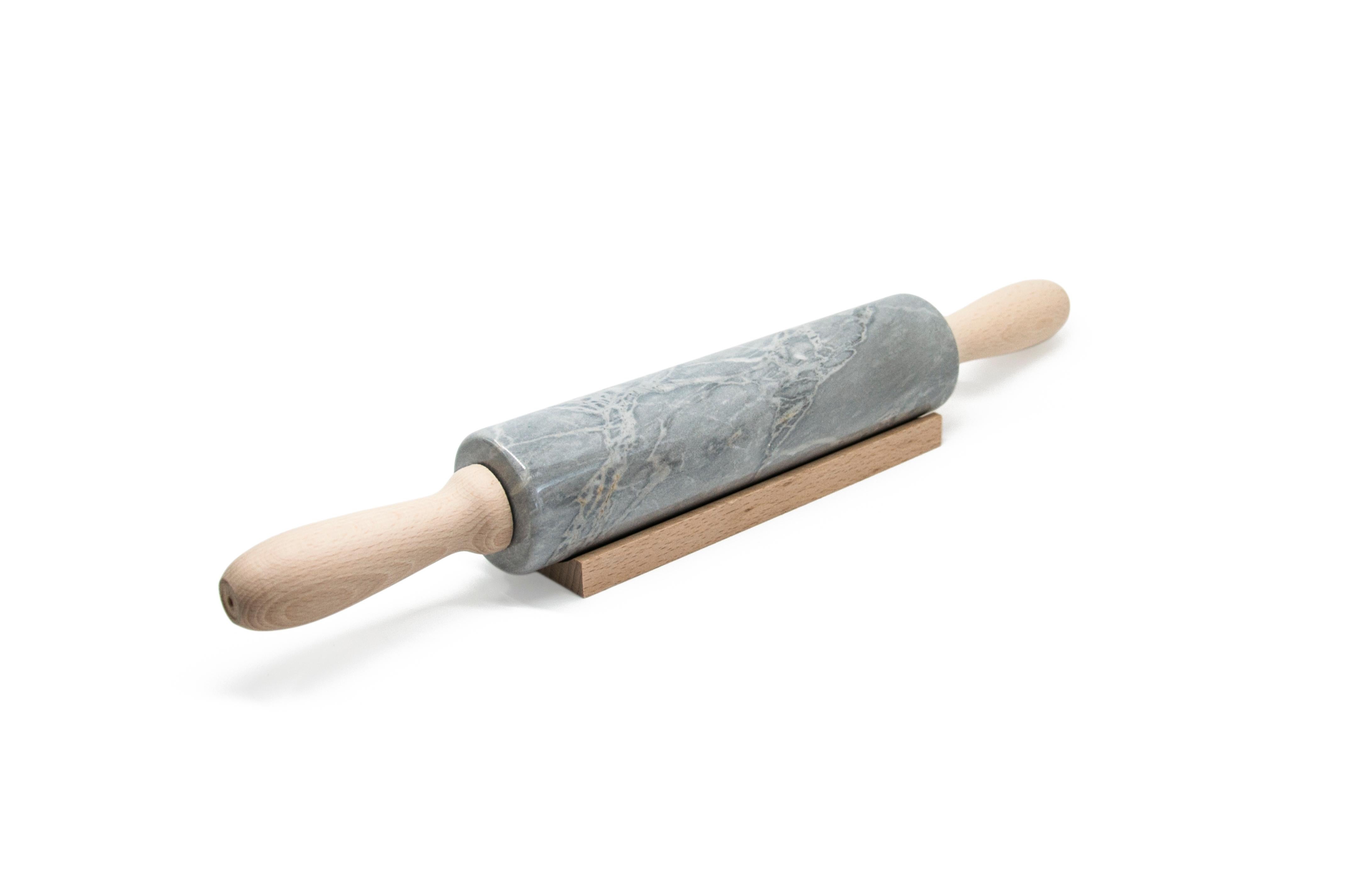 Grey Bardiglio marble rolling pin with wooden handles. It is assembled manually. Each piece is in a way unique (every marble block is different in veins and shades) and handmade by Italian artisans specialized over generations in processing marble.