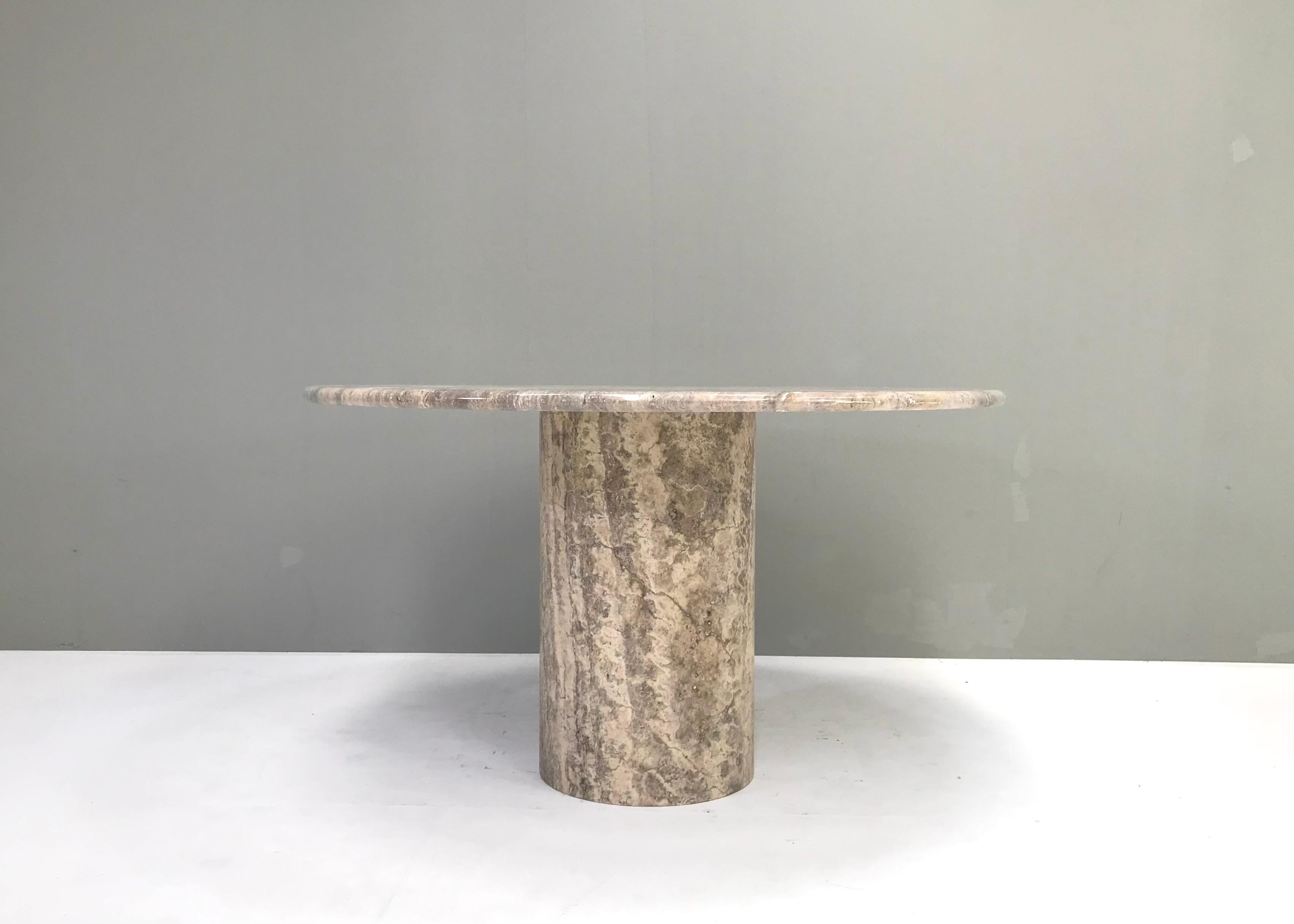 Amazing hand crafted round dining table in polished grey/brown/beige travertine. The base is cylindrical shaped and also made of one piece of the same travertine. The top is polished to a smooth and gloss surface which is very pleasant for use and