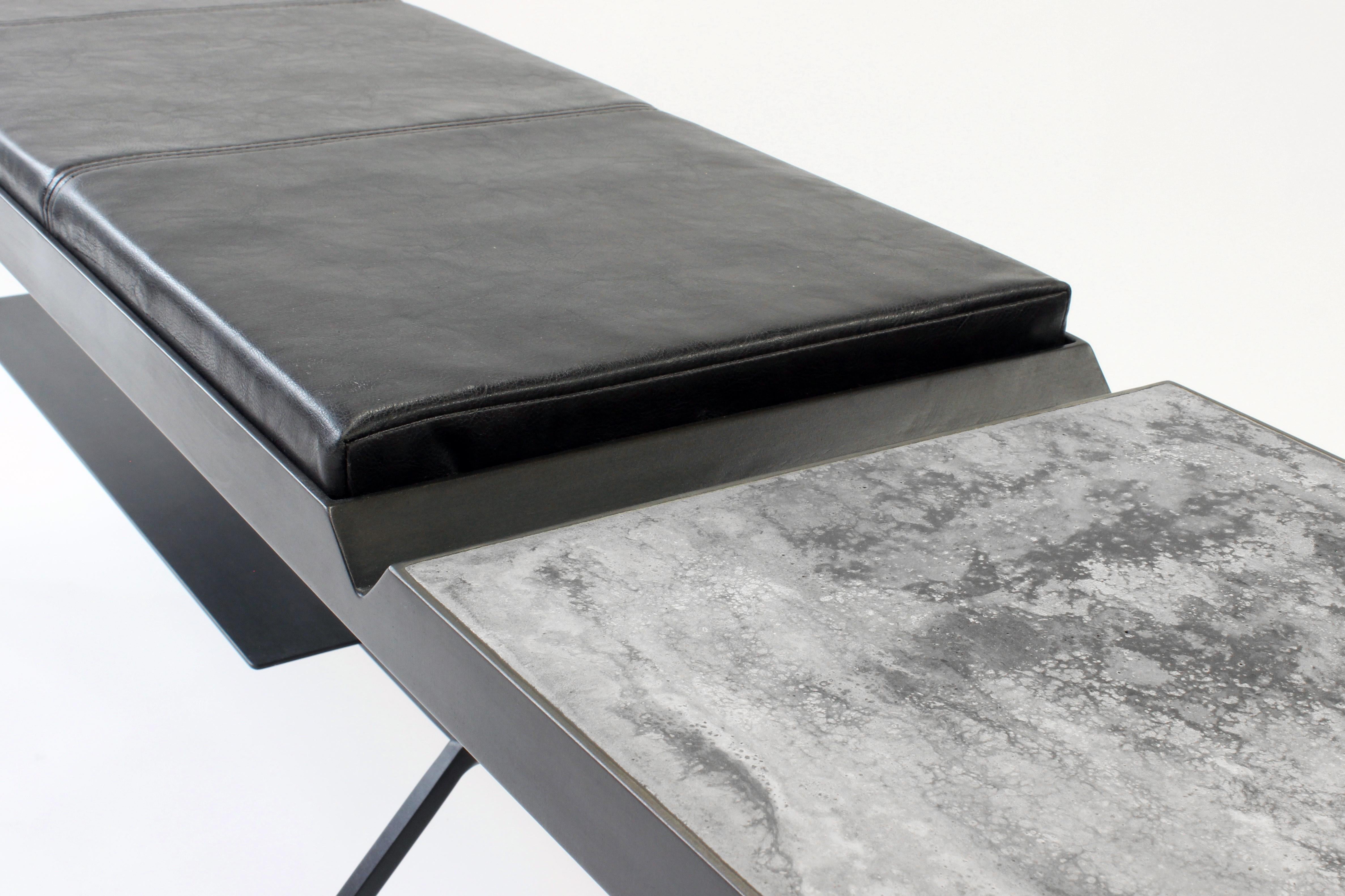 The Grey-Bird bench from Joshua Howe Design combines seating and a side table fluidly. An impossible steel “V” highlights the transition from poured concrete surface to faux leather cushion. An asymmetrical blackened steel frame with integrated