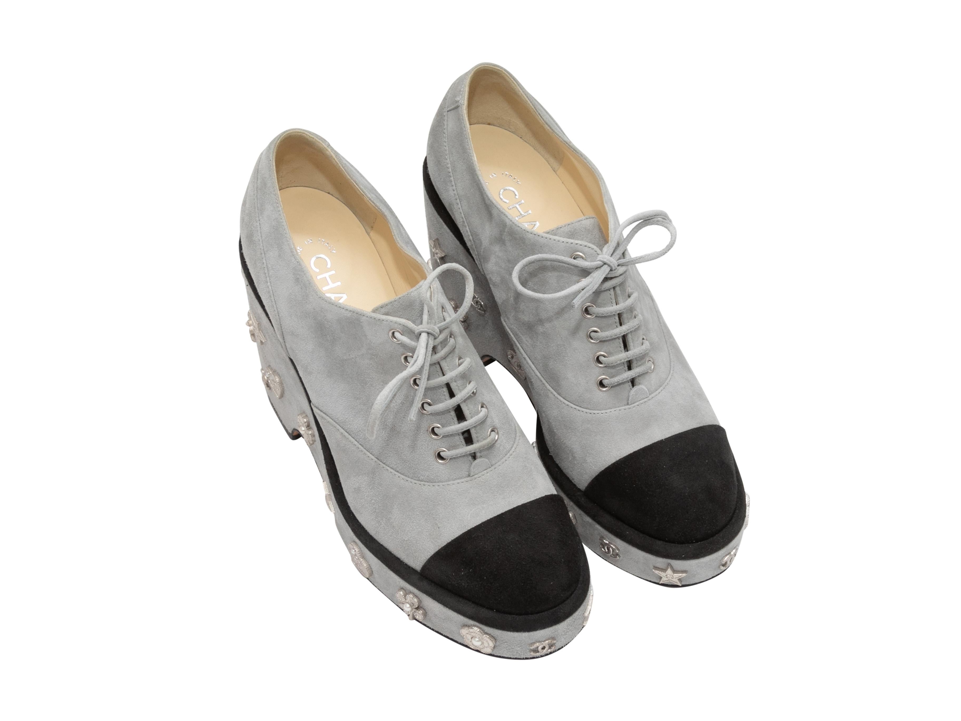  Grey and black suede cap-toe platform oxfords by Chanel. Silver-tone metal adornments at heels. Lace-up tie closures at tops. 2.5