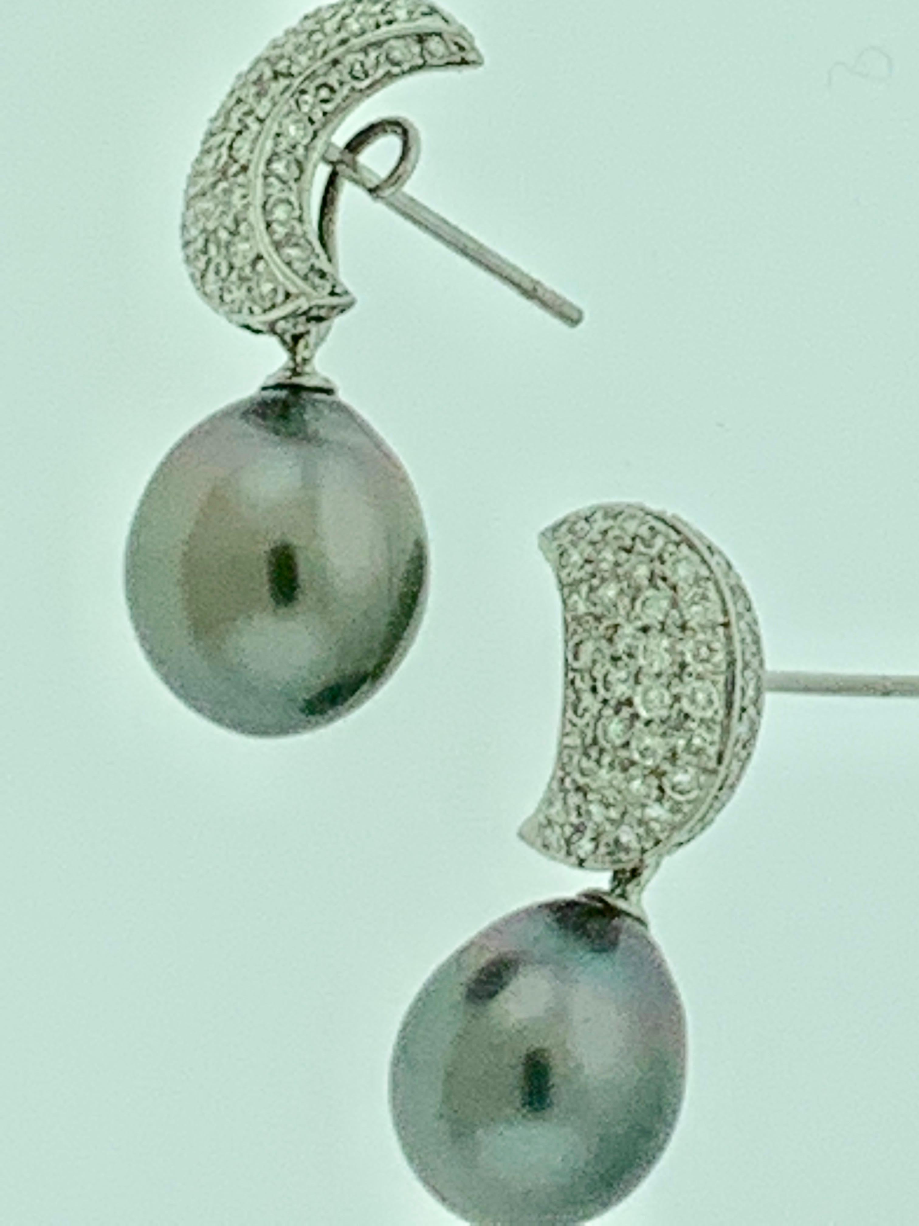 
A beautiful pair of 8-9 mm Tahitian South Sea cultured pearl earrings with gorgeous 18K gold mountings. 
Black Tahitian Cocktail Earrings With Diamonds 18 Karat White Gold 
All pearls are absolutely clean with no blemishes .Approximately 8 mm