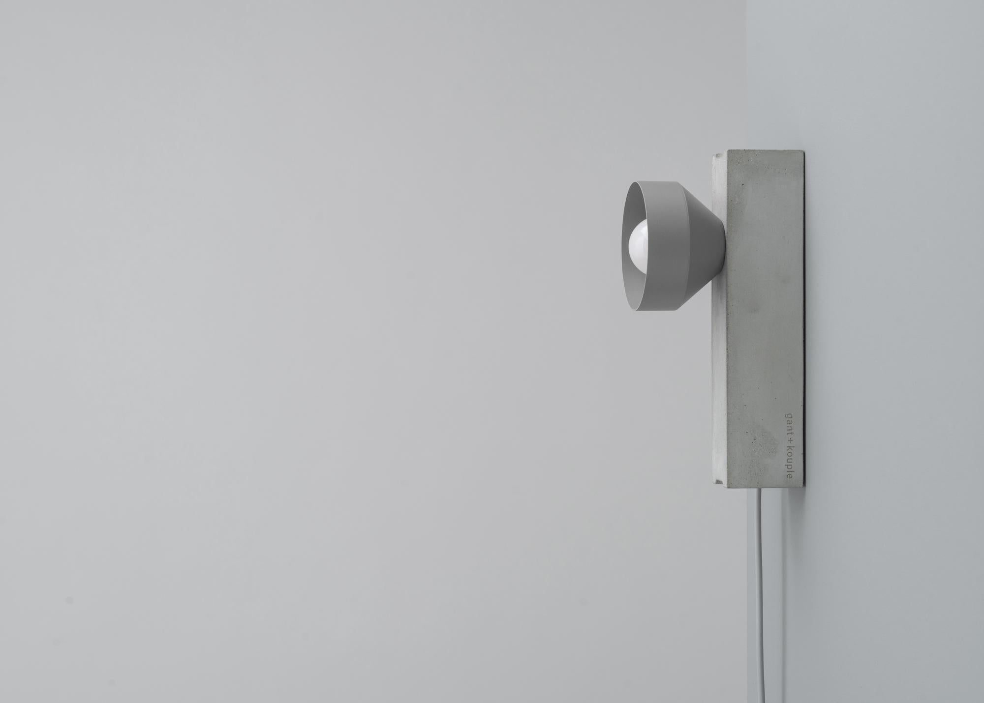 Grey Block Wall Lamp by +kouple
Dimensions: D 26 x W 10 x H 12,7 cm.
Materials: Concrete, powder-coated steel and textile. 

Available in different color options. Please contact us.

All our lamps can be wired according to each country. If sold to
