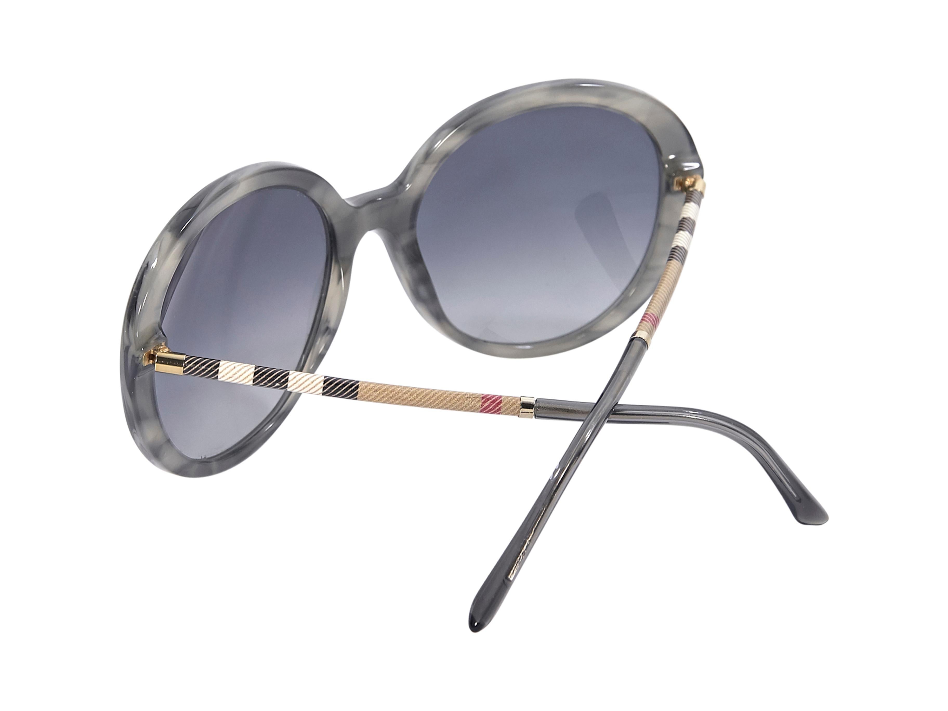 Product details:  Grey tortoise shell round sunglasses by Burberry.  Gradient lenses.  Plaid checked stems.  2.25