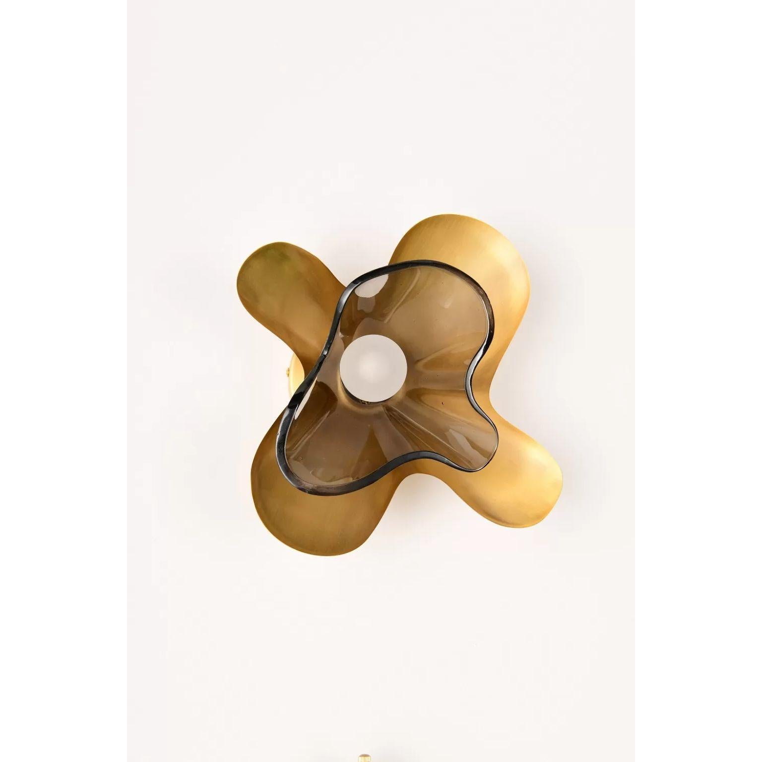 Grey Butterfly Wall Sconce by Dainte
Dimensions: D 13.5 x W 28.5 x H 28 cm.
Materials: Glass and brass. 

The Butterfly wall sconce features an elegant silhouette modeled after the wings of a butterfly in motion. Layered textured brass and glass, a