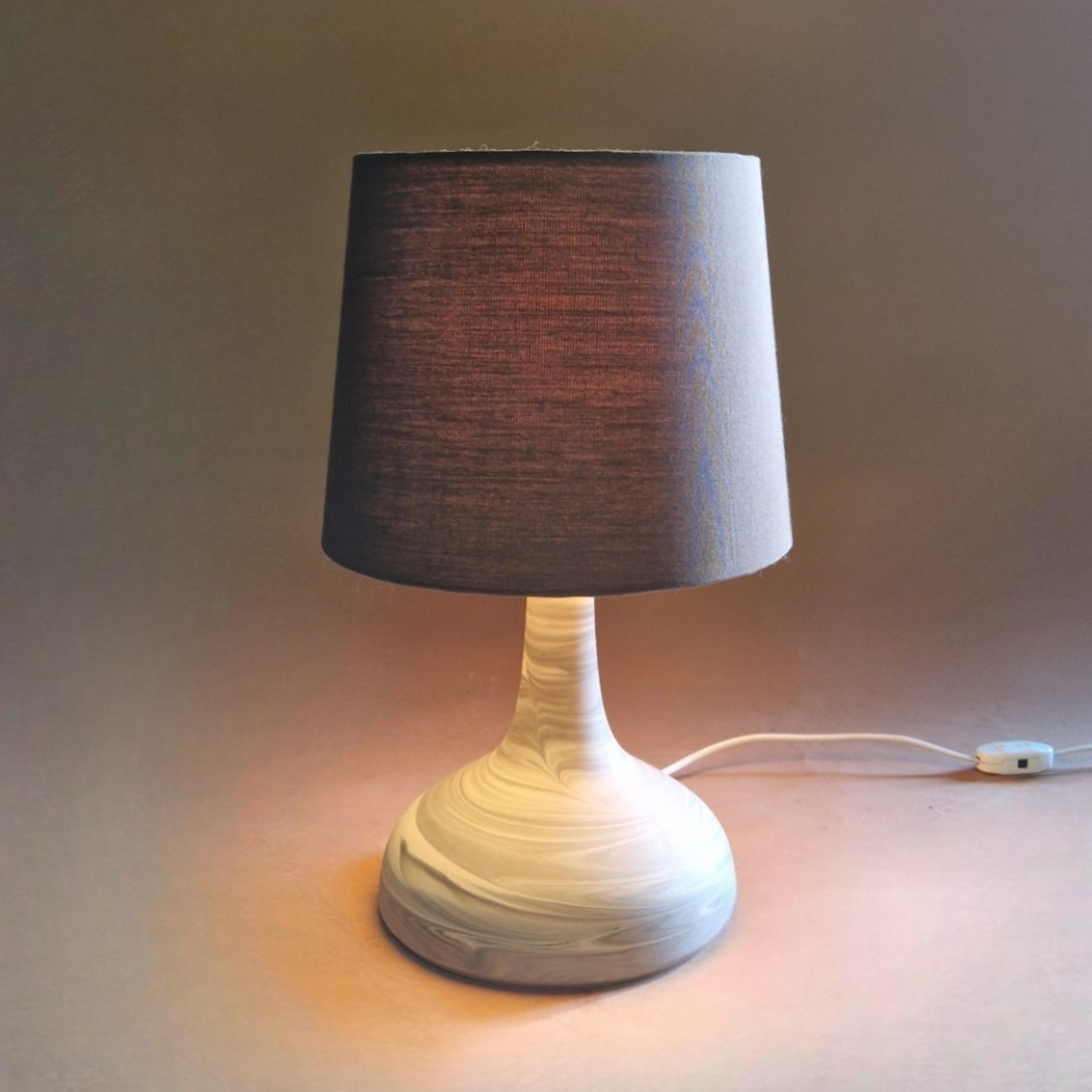 Ceramic mid century table lamp with a plexiglass diffusor and fabric shade. Most likely designed by Bjorn Wiinblad in the 1960s. The lamp is marked with the manufacturer stamp of Rosenthal. 
It is part of the 