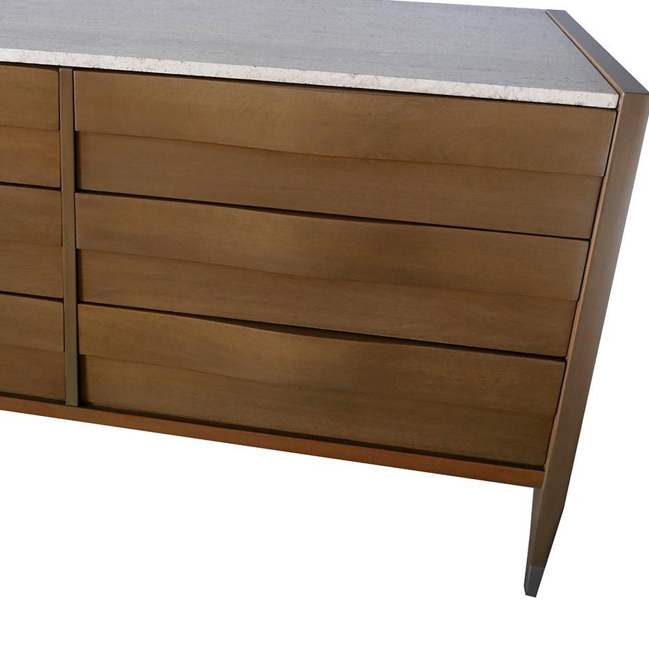 The inset-marble top above 6 drawers that wave and meet, all in grey cerused walnut, with square tapering legs and polished nickel caps.