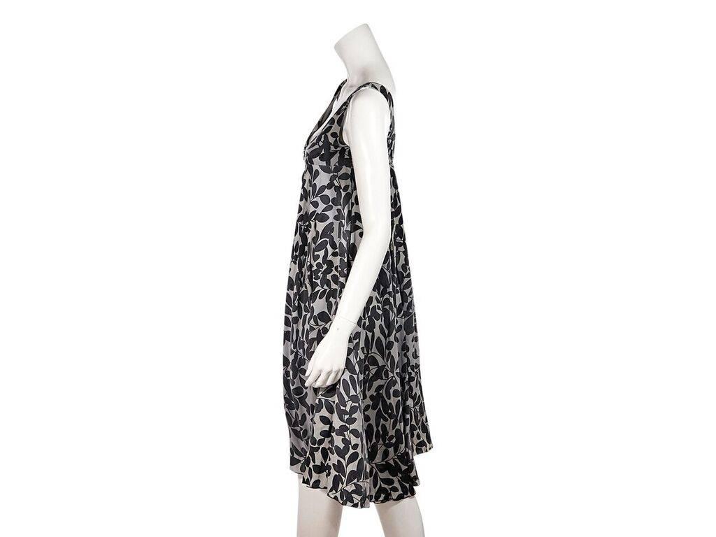 Product details:  Grey printed silk A-line dress by Dolce & Gabbana.  Deep scoopneck.  Sleeveless.  Zip-front closure.  Scoopback.  Label size IT 42.  34