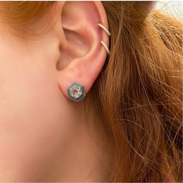 A geometric stud earring that features a stunning combination of grey enamel surrounding custom cut soft green topaz.  The hexagon shape and enamel are a new take on the classic stud.  These are perfect to wear from the gym to dinner.