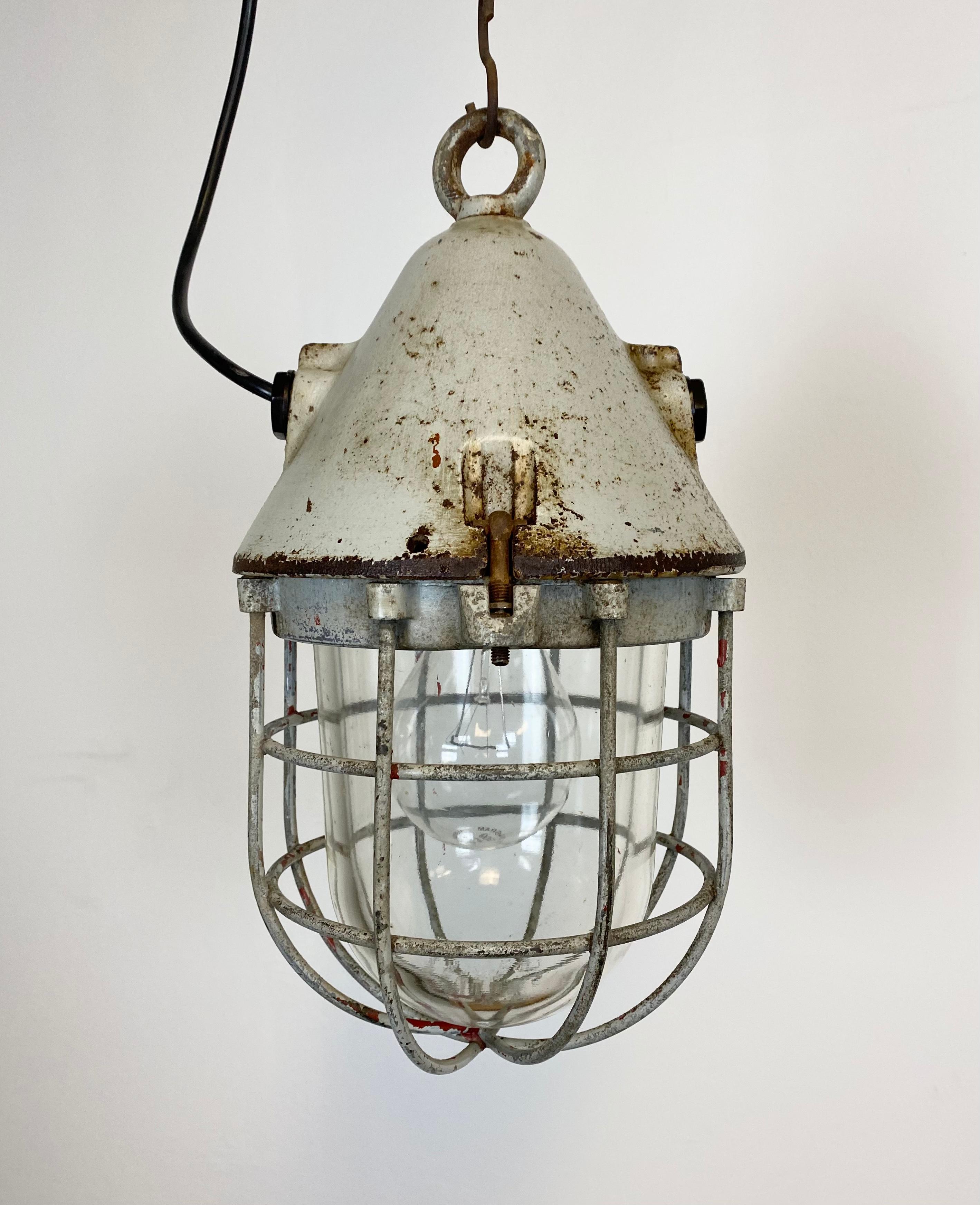 - Industrial bunker lamp made by EOW in East Germany during the 1960s
- Used in power plants and mines
- Made of cast iron and explosion-proof glass
- Porcelain socket requires E 27 lightbulbs
- Weighs 6 kg.