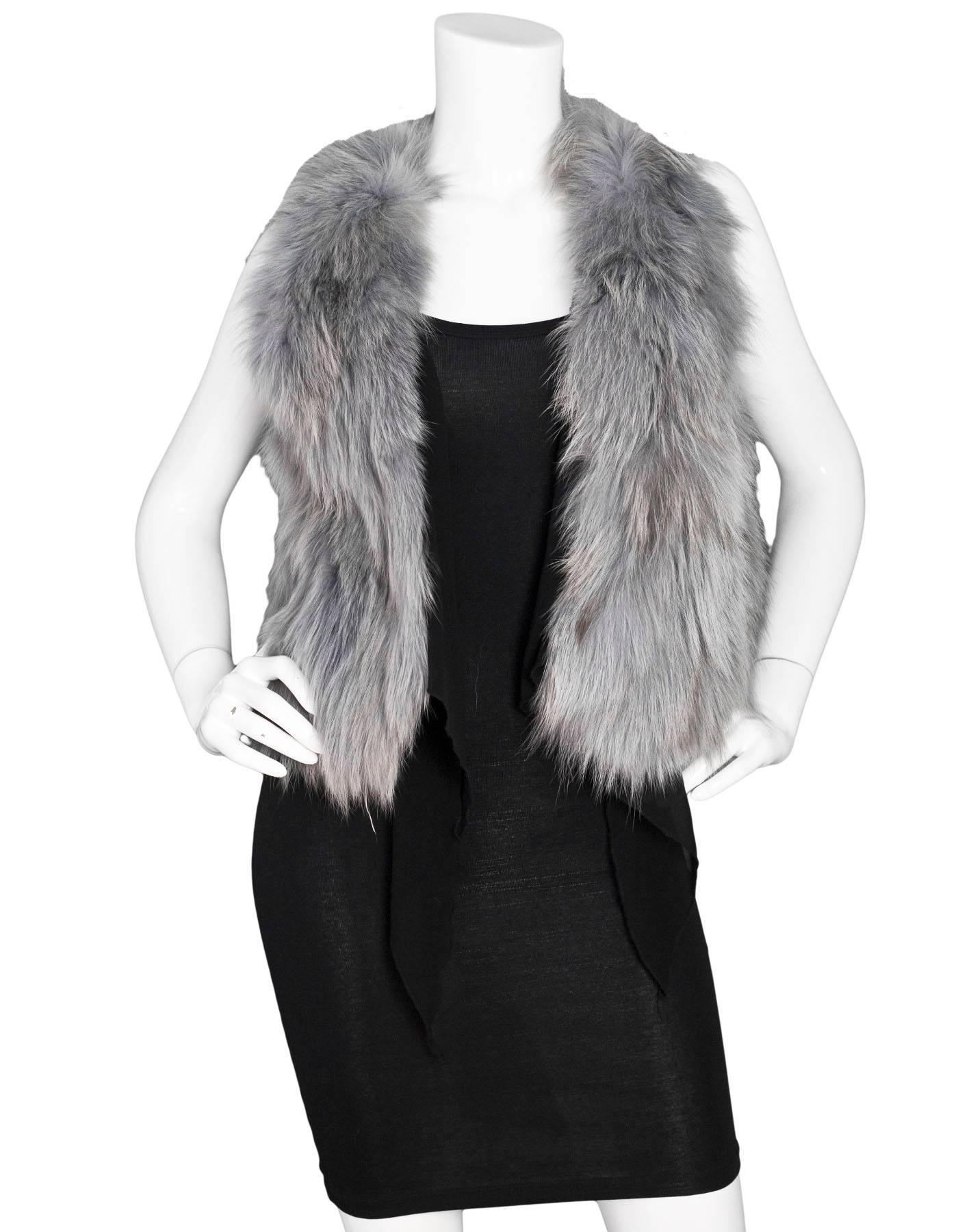 Grey Fox Fur Vest

Features black draping at front

Color: Grey
Composition: Fox
Lining: Textile
Closure/Opening: Open front
Exterior Pockets: None
Overall Condition: Excellent pre-owned condition, faint discoloration at front
Measurements:
Bust: