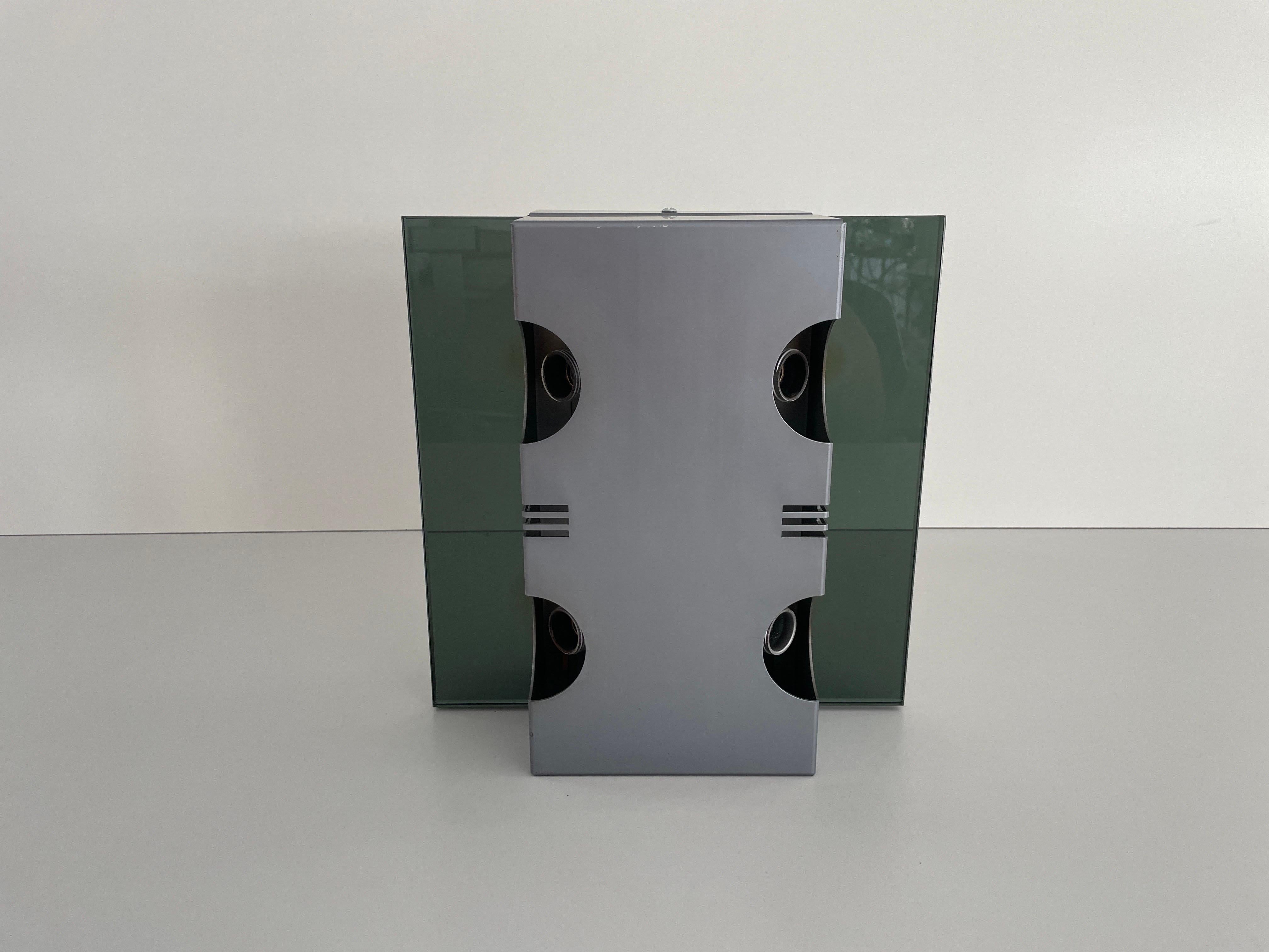 Grey Glass & Metal Ufo Design Single Wall Lamp by Luci, 1970s, Italy

Minimalist and rare design 

Lampshade is in good condition and very clean. 
This lamp works with 4x E14 light bulbs. 
Max 100W Wired and suitable to use with 220V and 110V for