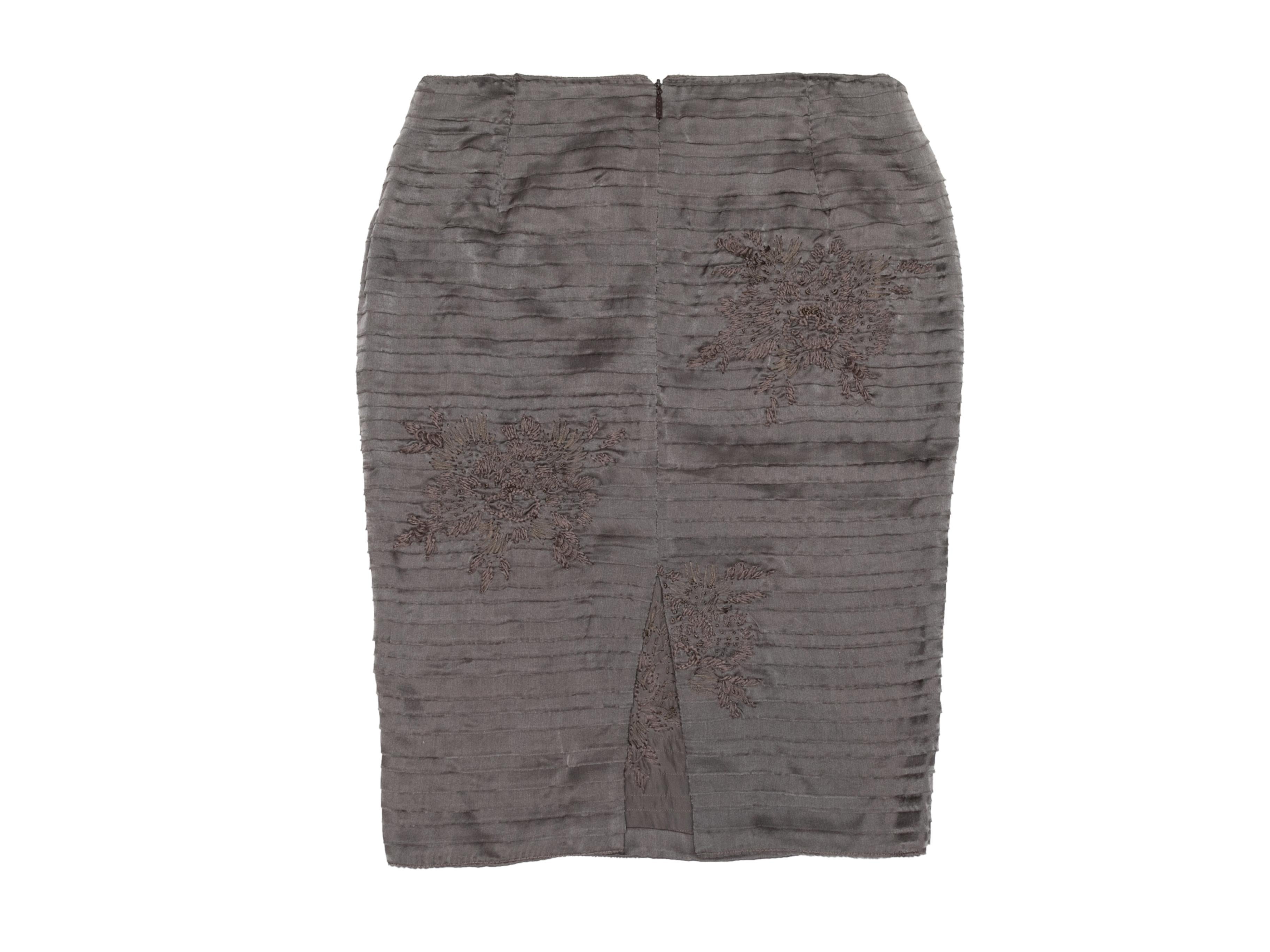 Grey Pleated silk skirt by Gucci. Floral embroidery throughout. Zip closure at back. 26